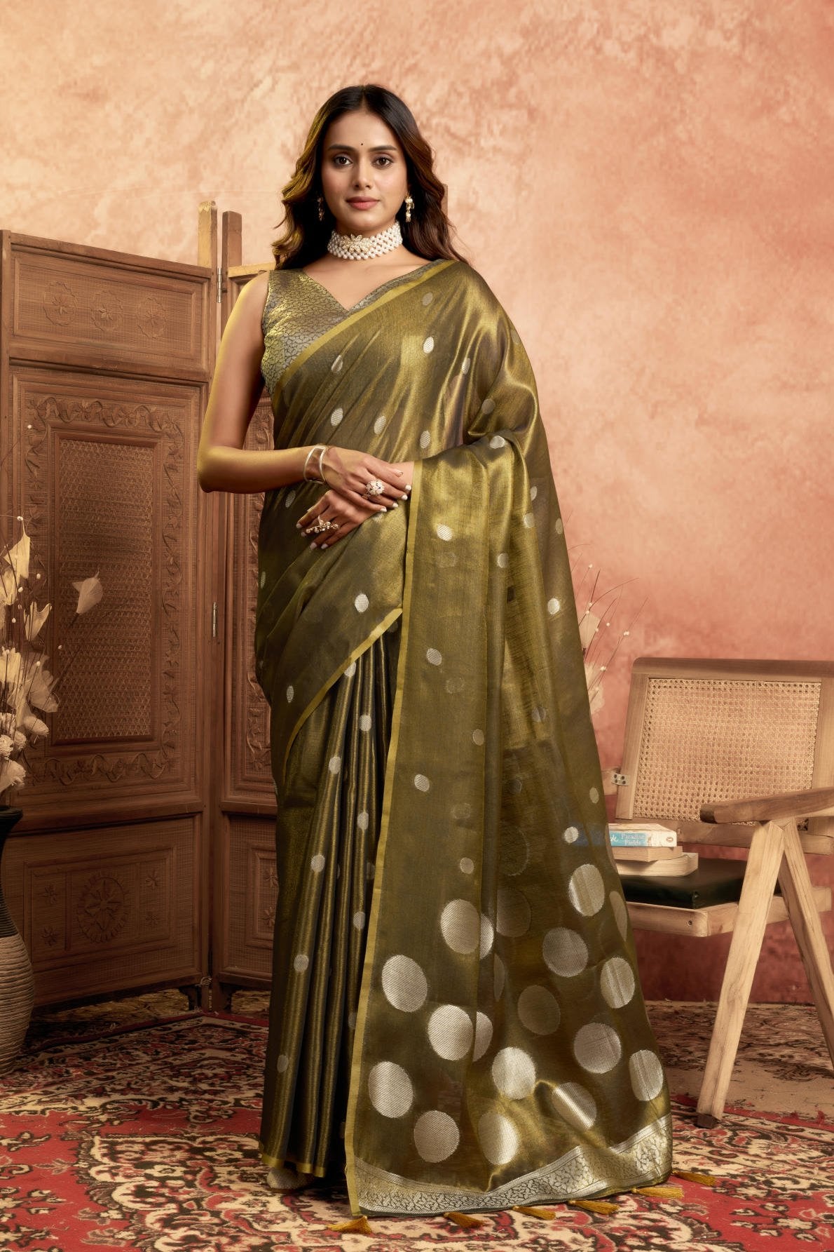 A Pure Tissue Silk Saree defined by its shimmering texture and continuous Pola Weave pattern throughout the body. The design is completed with a richly woven border detail on the pallu and includes a matching All-over Weave Tissue Silk Blouse piece, packaged as a six-piece set.