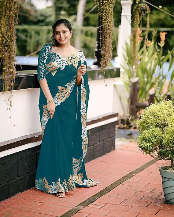 Woman wearing satin chiffon silk saree with large leaf jari embroidery and cutwork border