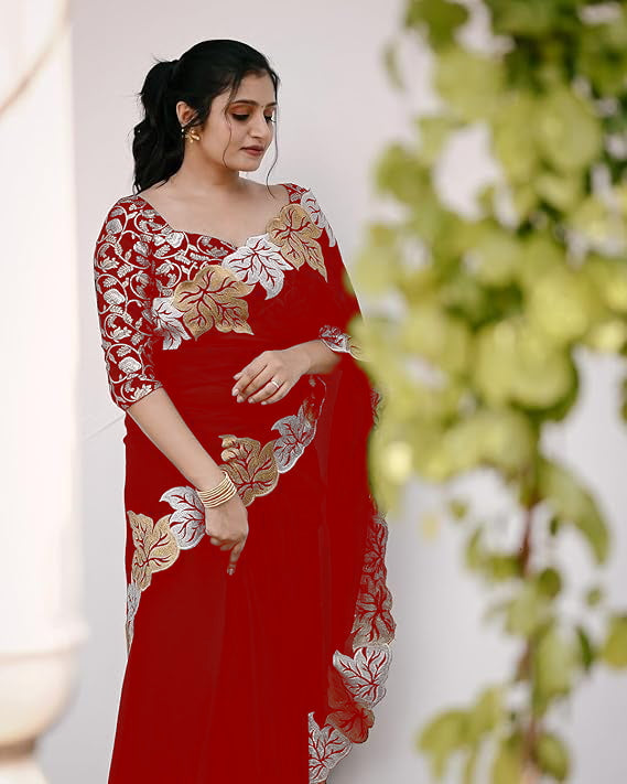 Woman wearing satin chiffon silk saree with large leaf jari embroidery and cutwork border