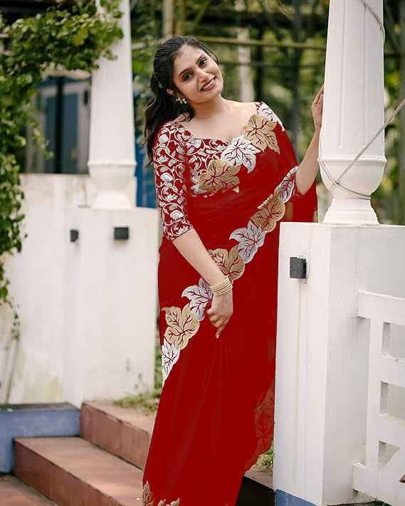 Woman wearing satin chiffon silk saree with large leaf jari embroidery and cutwork border