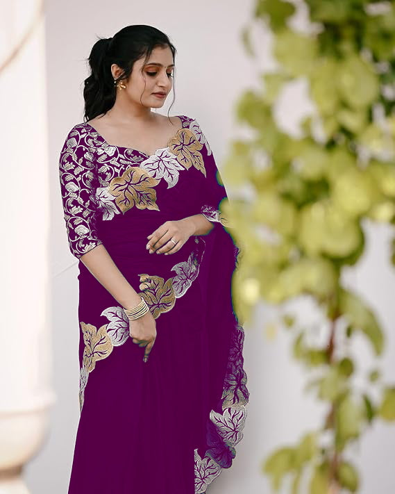 Woman wearing satin chiffon silk saree with large leaf jari embroidery and cutwork border