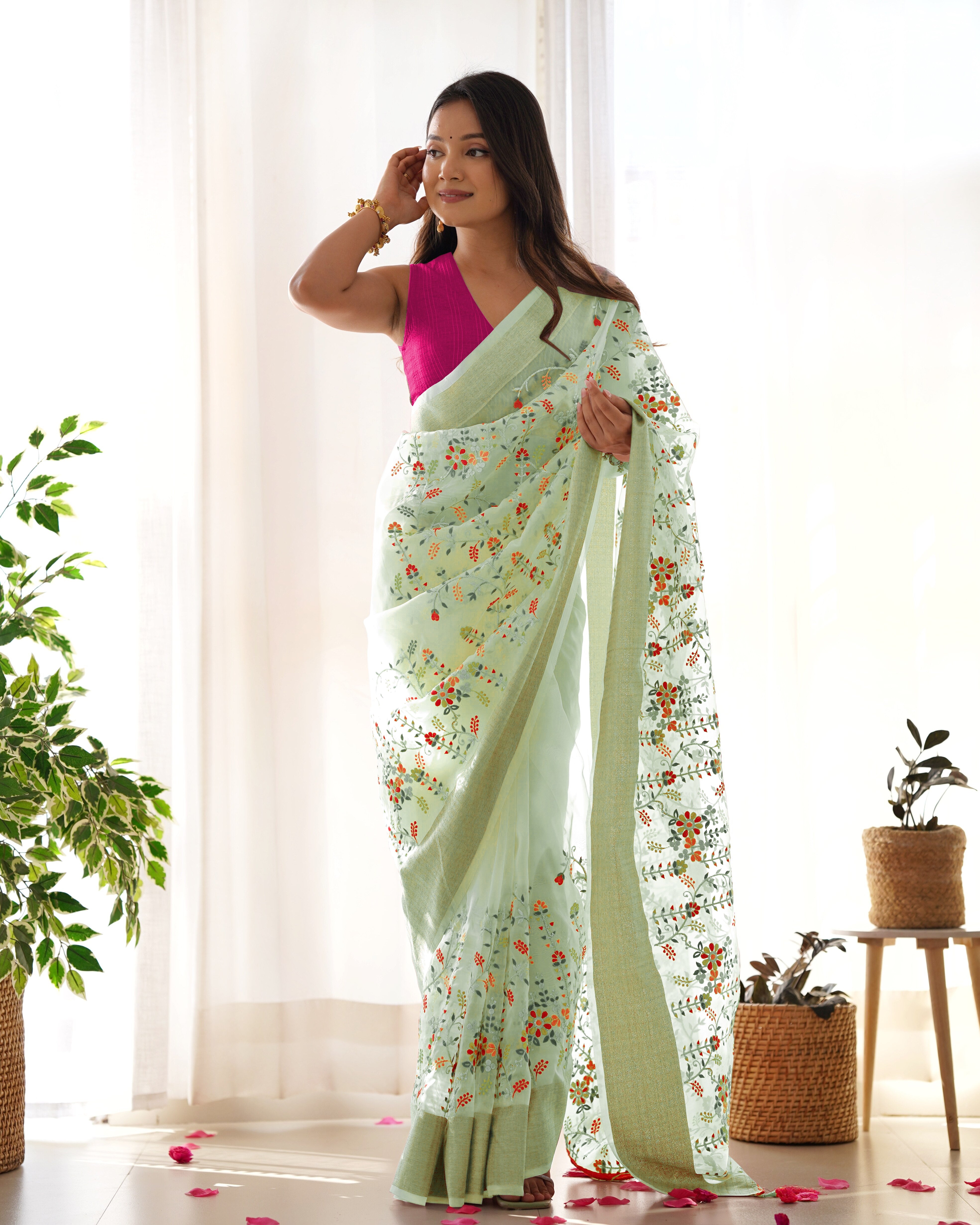 Cream pure organza silk saree with multicolor floral embroidery and solid pink blouse worn by a model