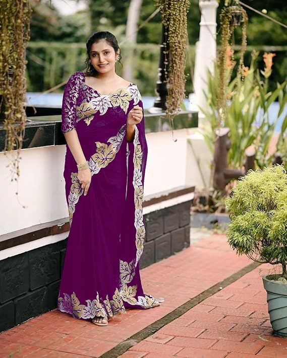 Woman wearing satin chiffon silk saree with large leaf jari embroidery and cutwork border