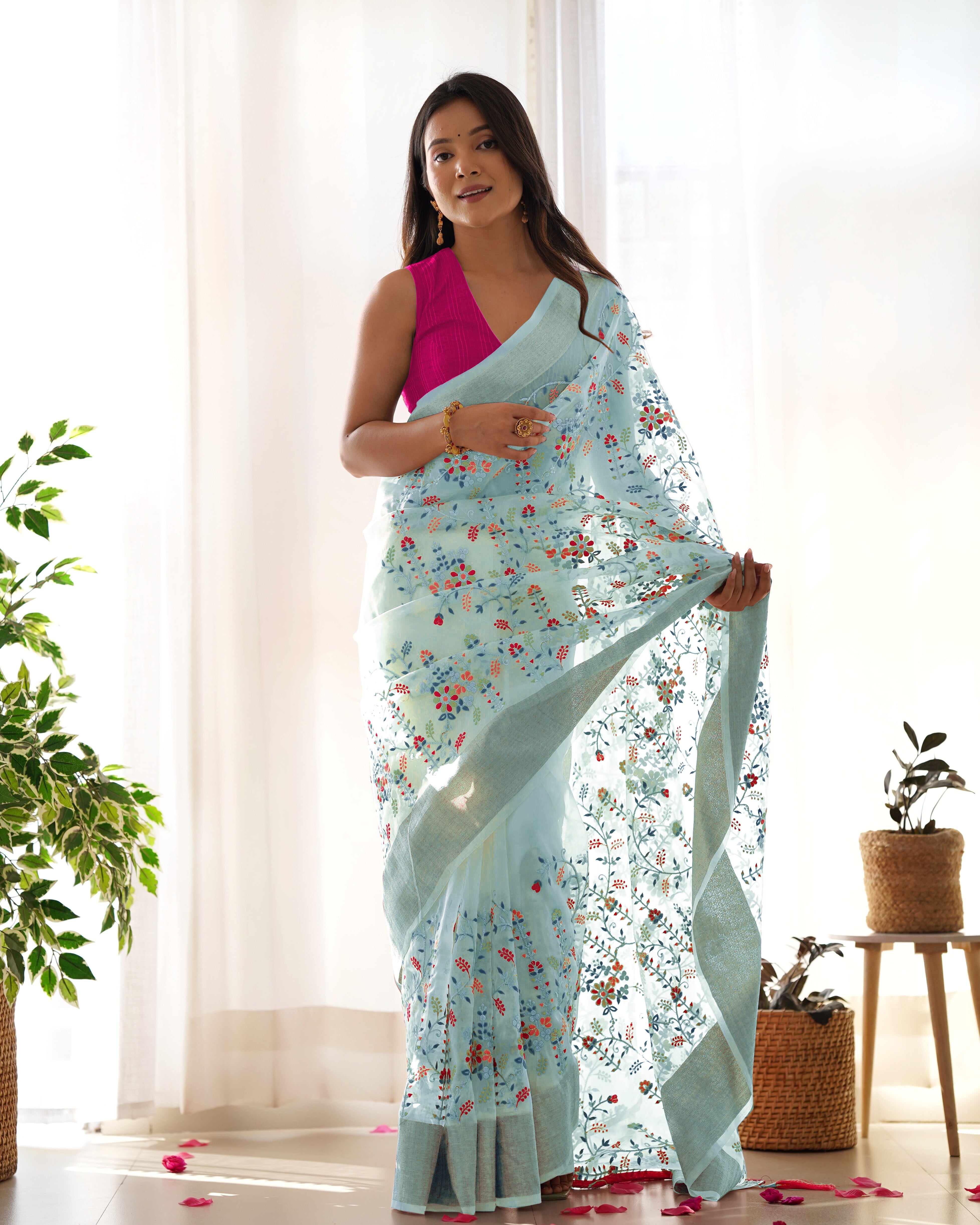 Cream pure organza silk saree with multicolor floral embroidery and solid pink blouse worn by a model