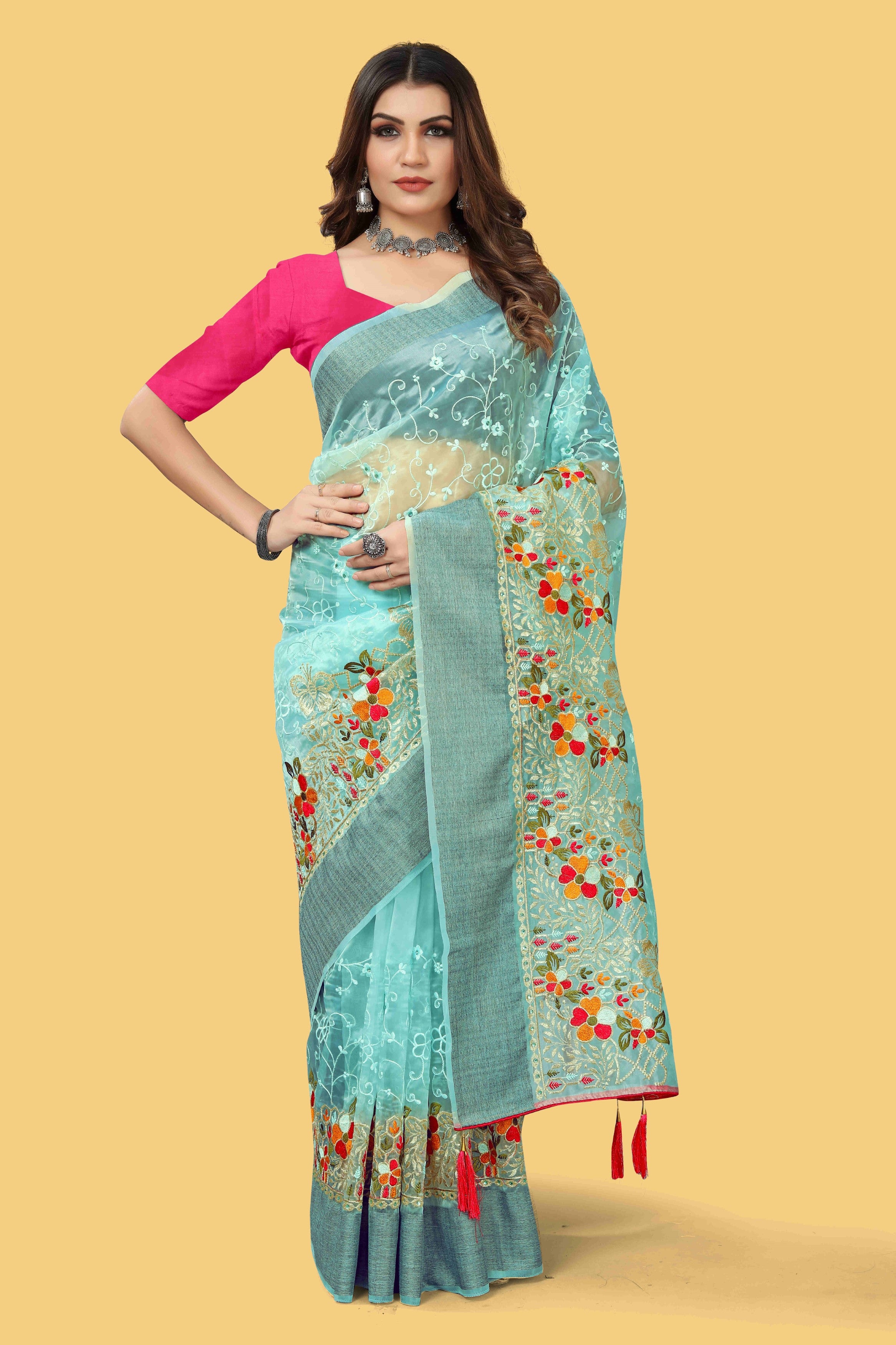 Floral embroidered organza silk saree with zari border, stone work, and contrast pink blouse