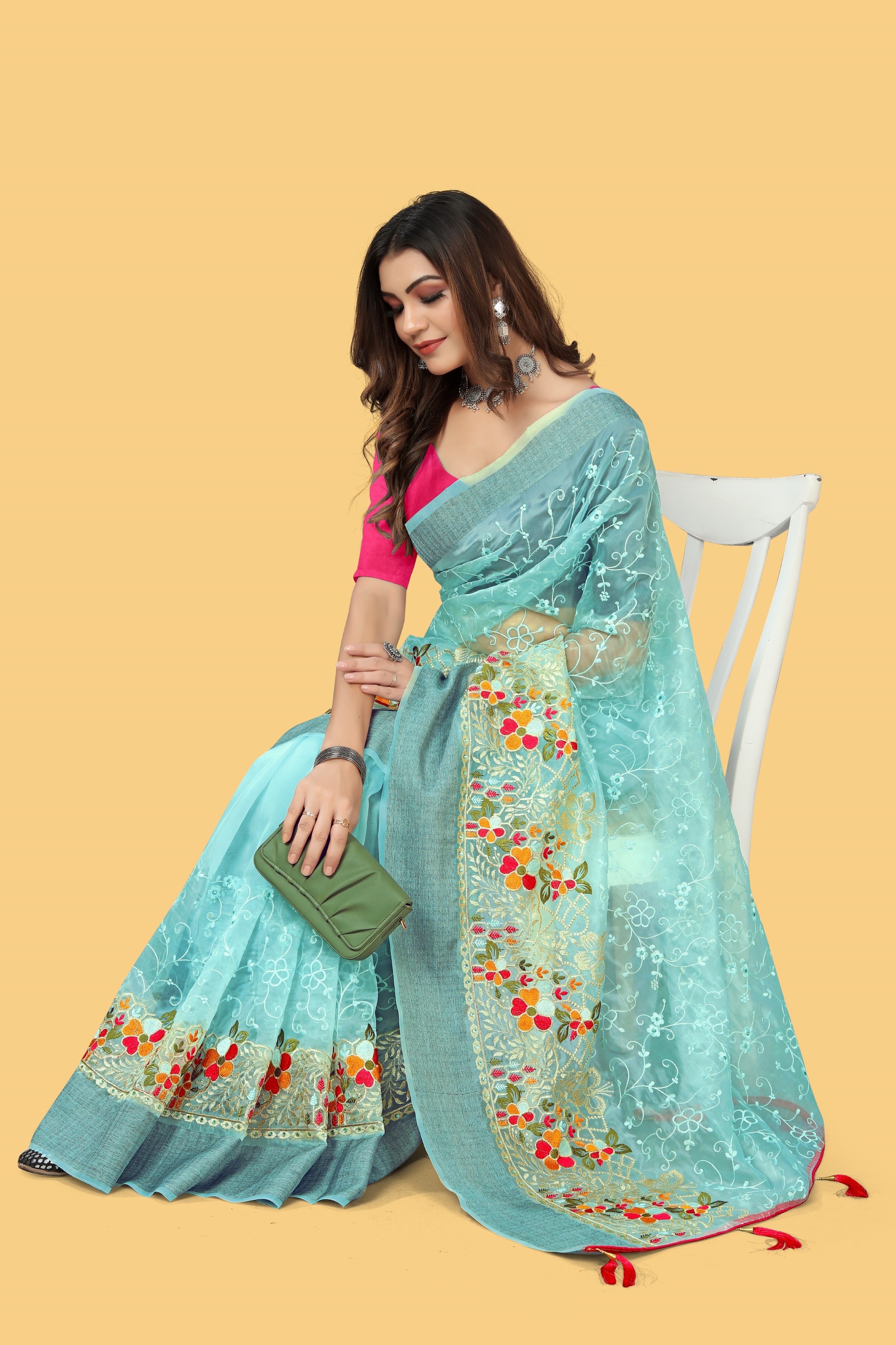 Floral embroidered organza silk saree with zari border, stone work, and contrast pink blouse
