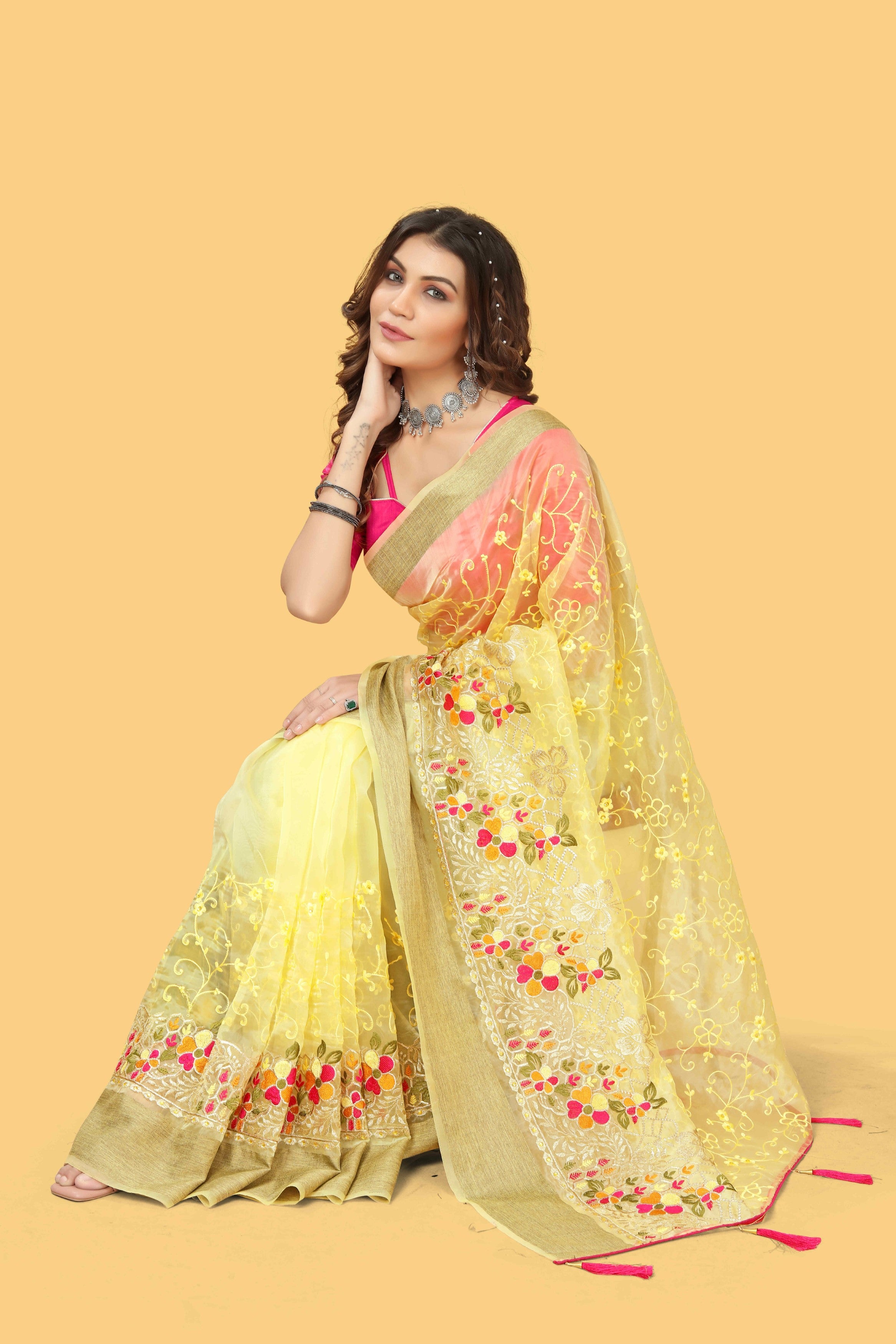 Floral embroidered organza silk saree with zari border, stone work, and contrast pink blouse
