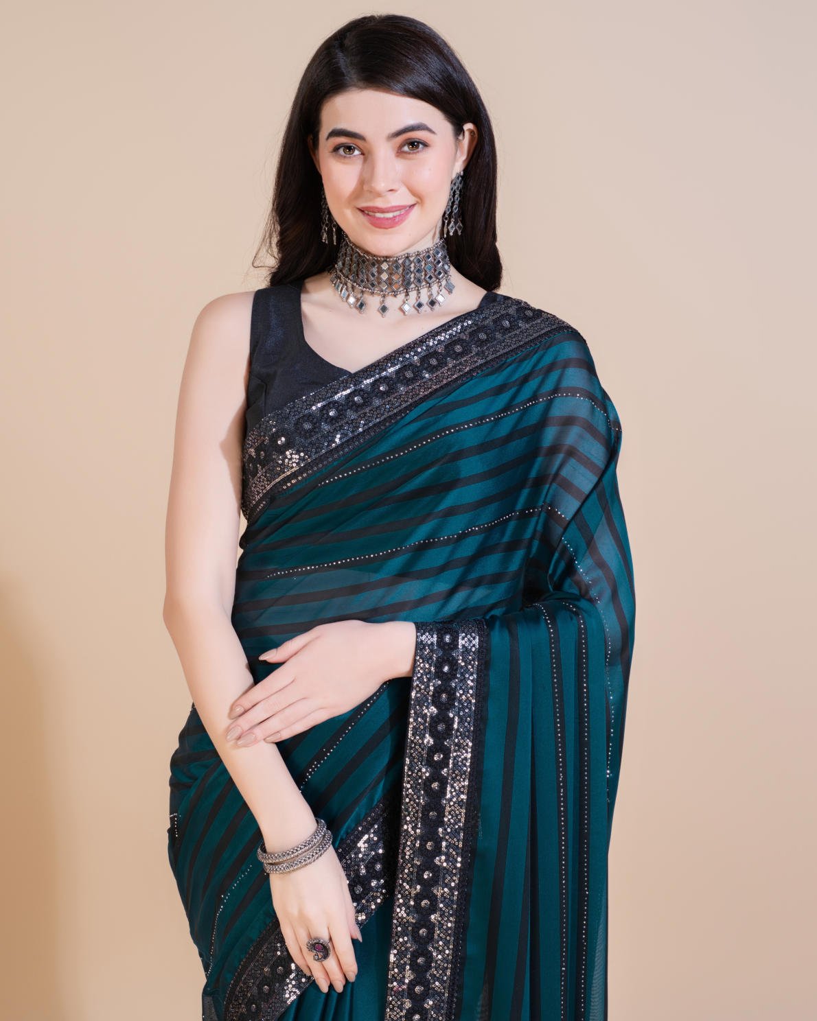 Model wearing Rangoli Silk Leheriya saree with black stripes, hotfix work, and sequin embroidered border