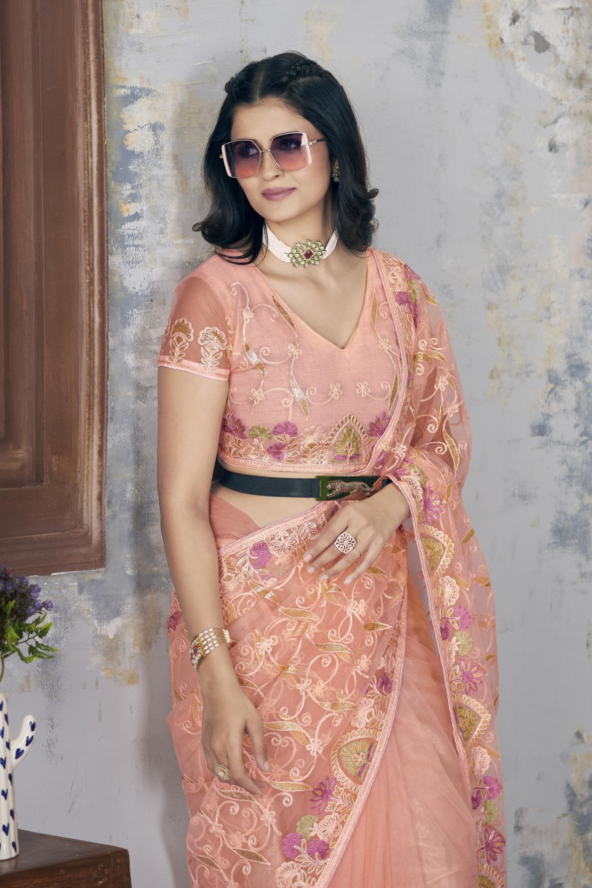 Model wearing Firozi heavy butterfly net saree with Aari Dori and foil thread embroidery suitable for weddings