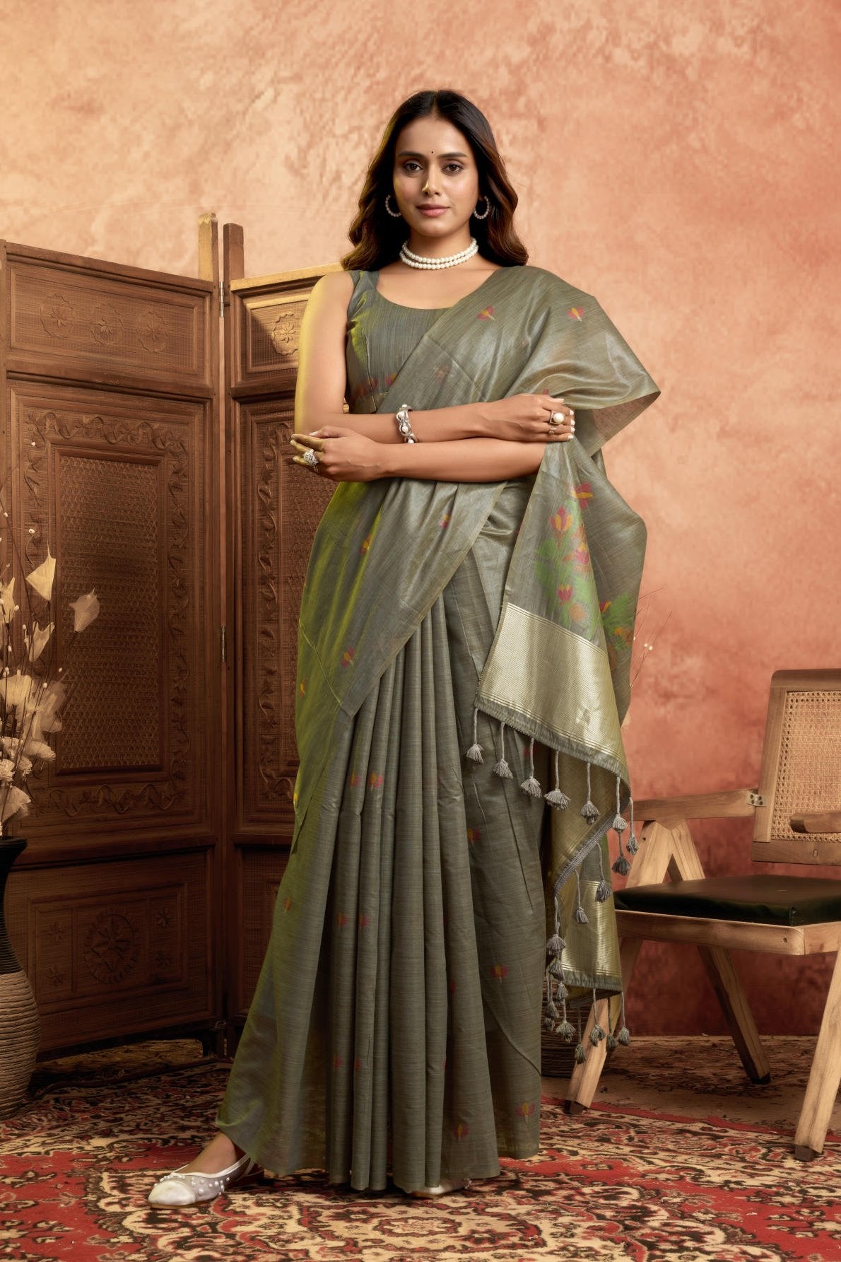 A Pure Cotton Spun Saree featuring delicate, traditional floral Jamdani weaving throughout the body. The pallu is accentuated with an elegant Zari weave border, and it comes with a running blouse piece that includes a matching floral weave border, sold as a six-piece set.