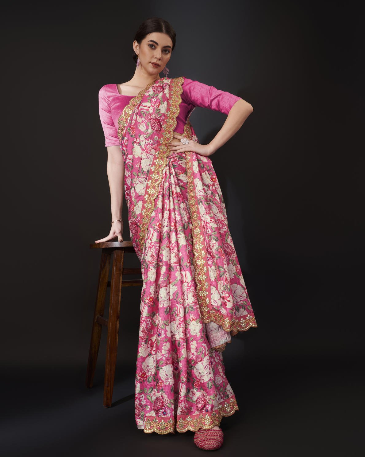 Yellow Vichitra Silk Saree with floral digital print and Zari Dori embroidered border worn by model holding white handbag