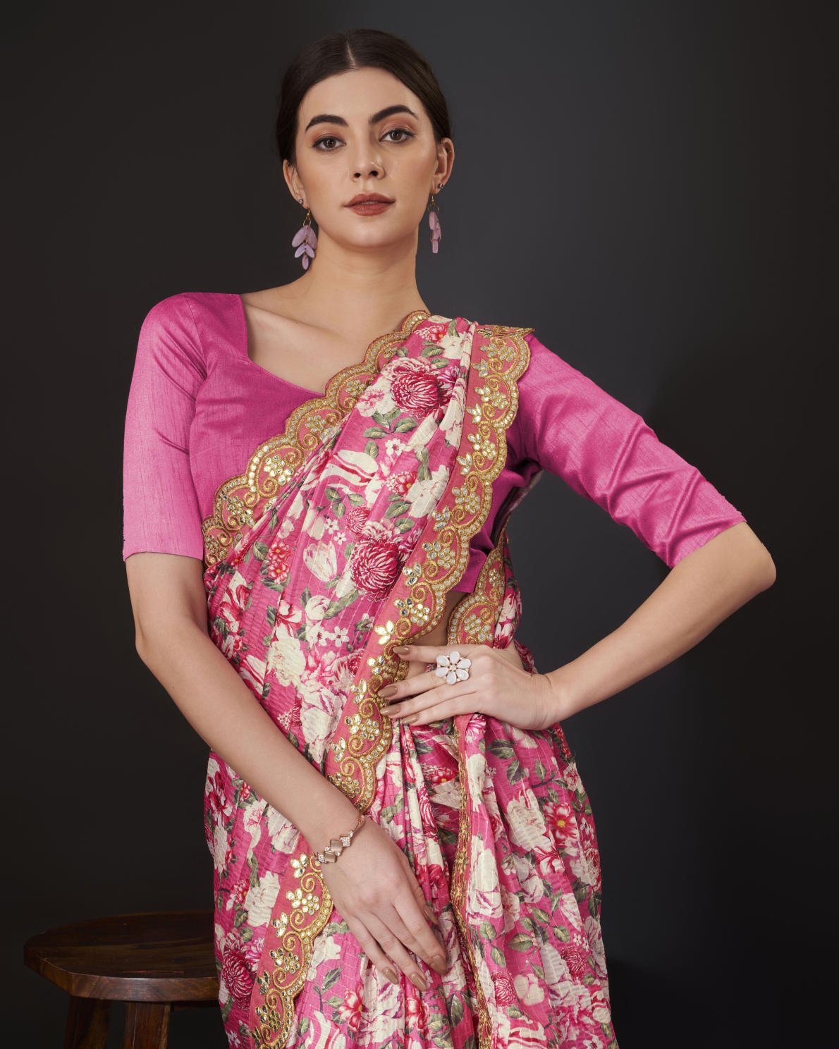 Yellow Vichitra Silk Saree with floral digital print and Zari Dori embroidered border worn by model holding white handbag