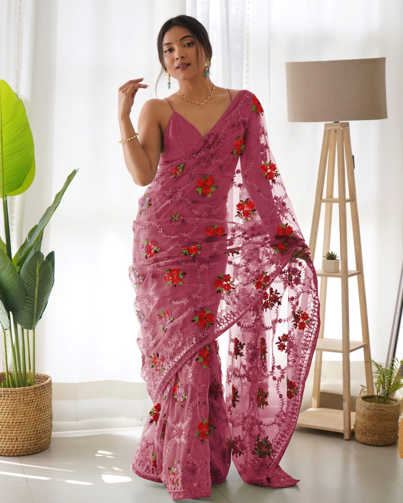 Mustard yellow heavy butterfly net saree with red and green floral aari embroidery and stone work