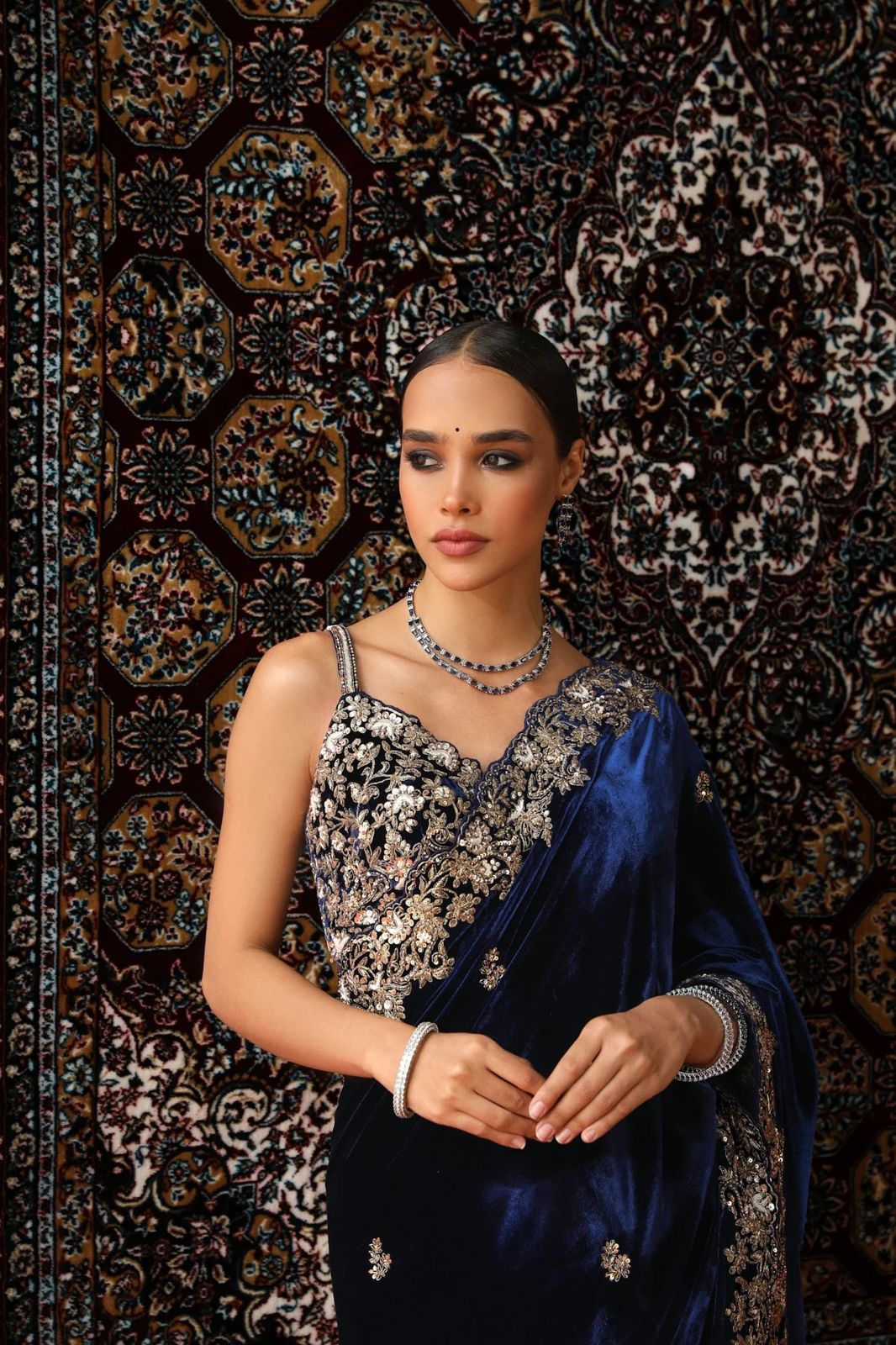 Model wearing luxurious 9000 velvet saree with silver sequence and zari embroidery cutwork border for wedding reception