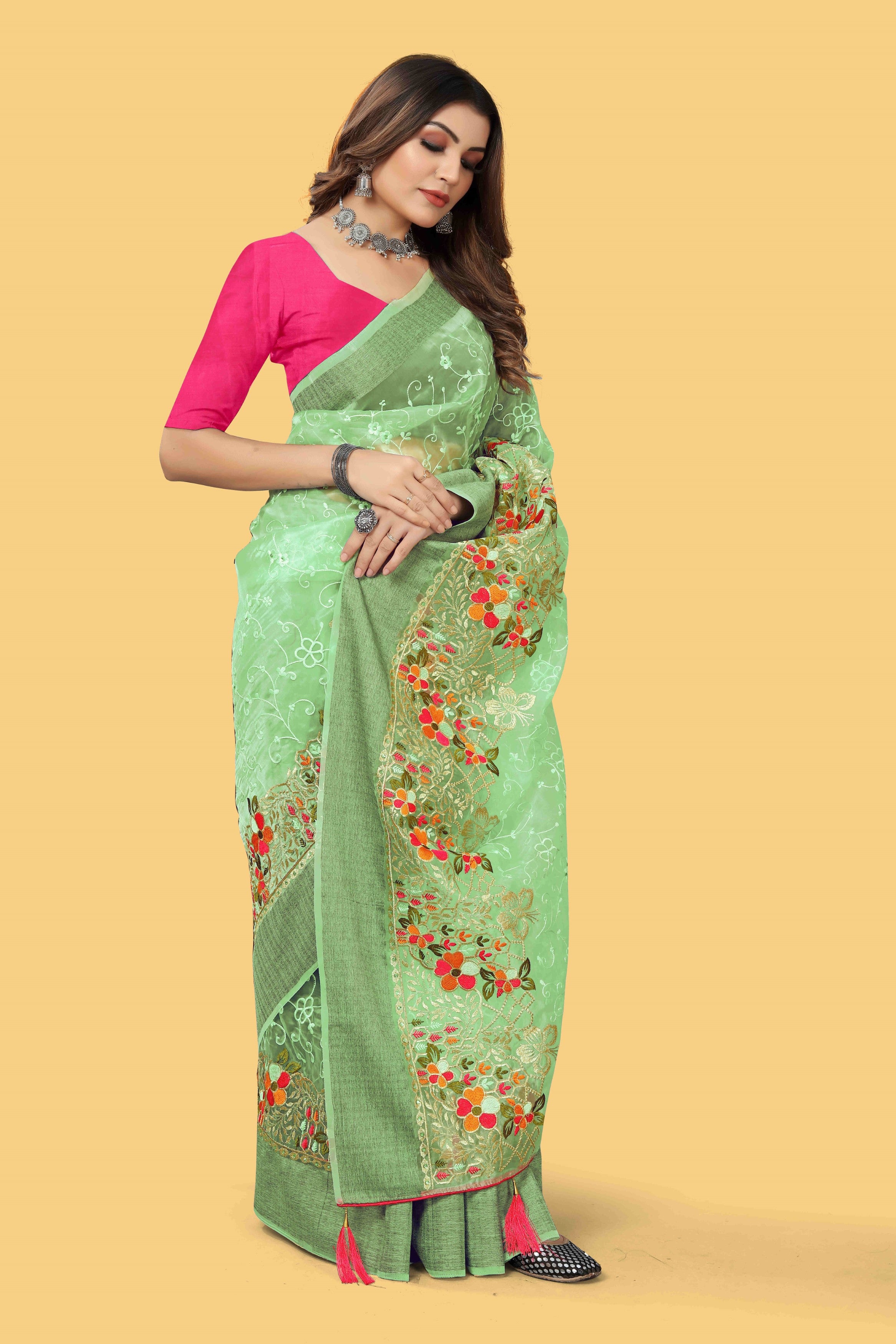 Floral embroidered organza silk saree with zari border, stone work, and contrast pink blouse