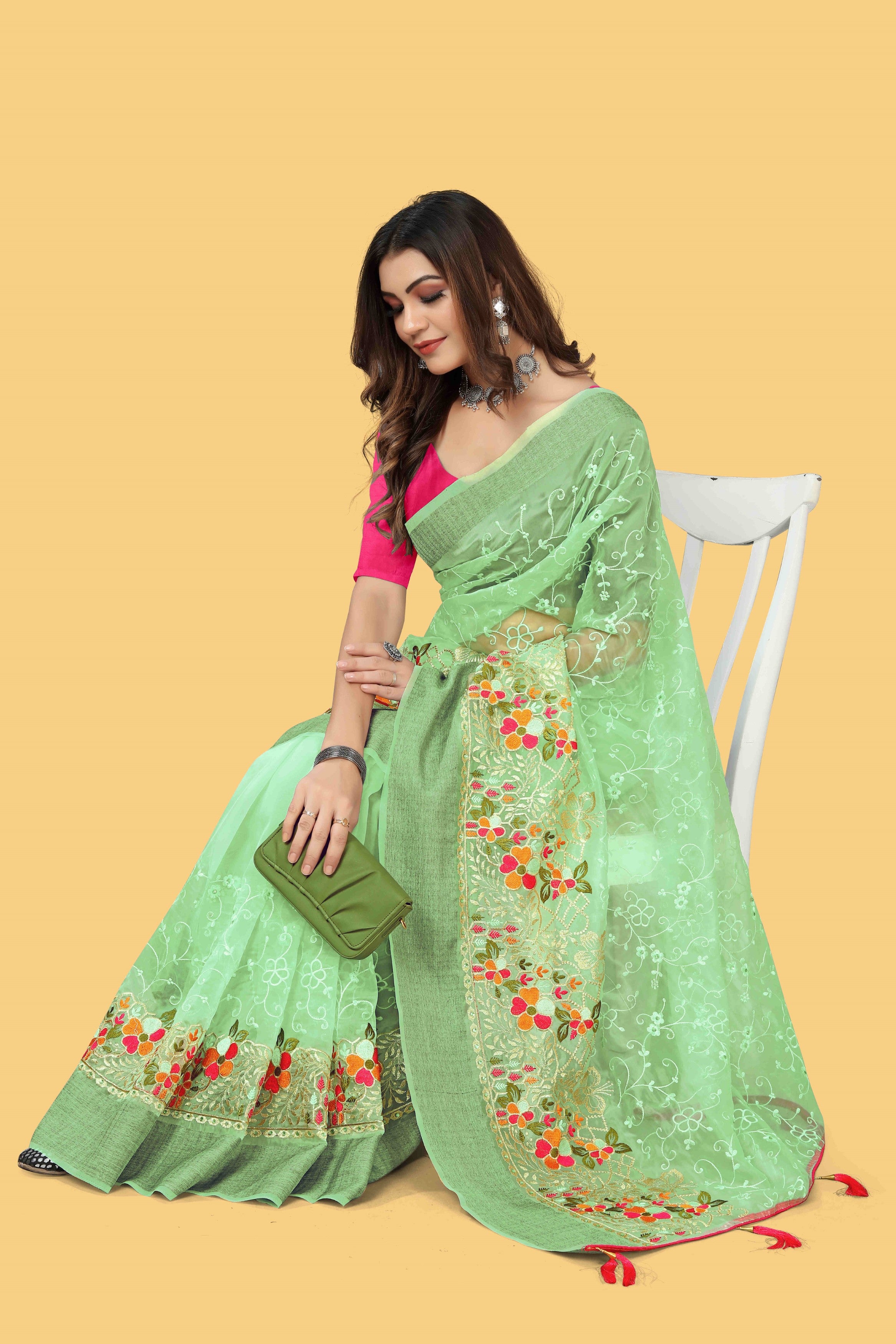 Floral embroidered organza silk saree with zari border, stone work, and contrast pink blouse