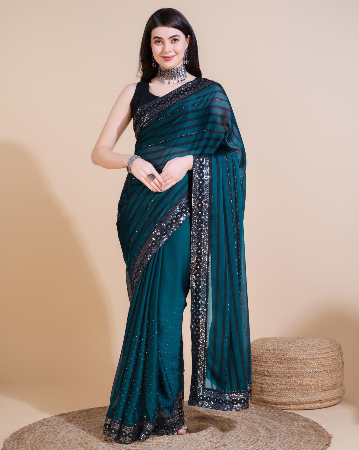 Model wearing Rangoli Silk Leheriya saree with black stripes, hotfix work, and sequin embroidered border