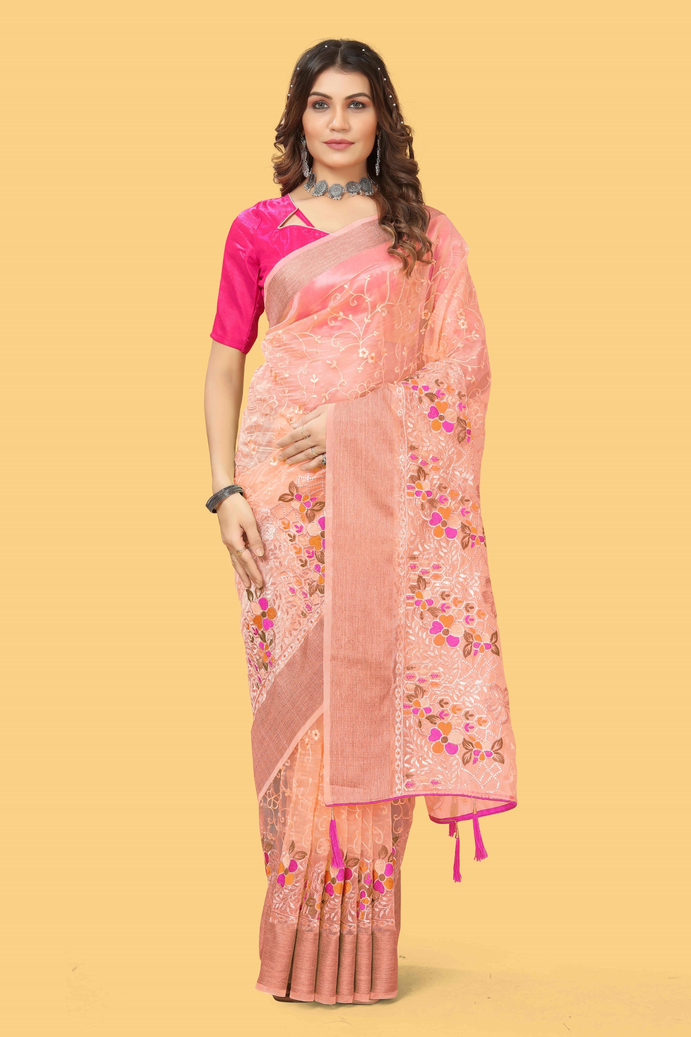 Floral embroidered organza silk saree with zari border, stone work, and contrast pink blouse