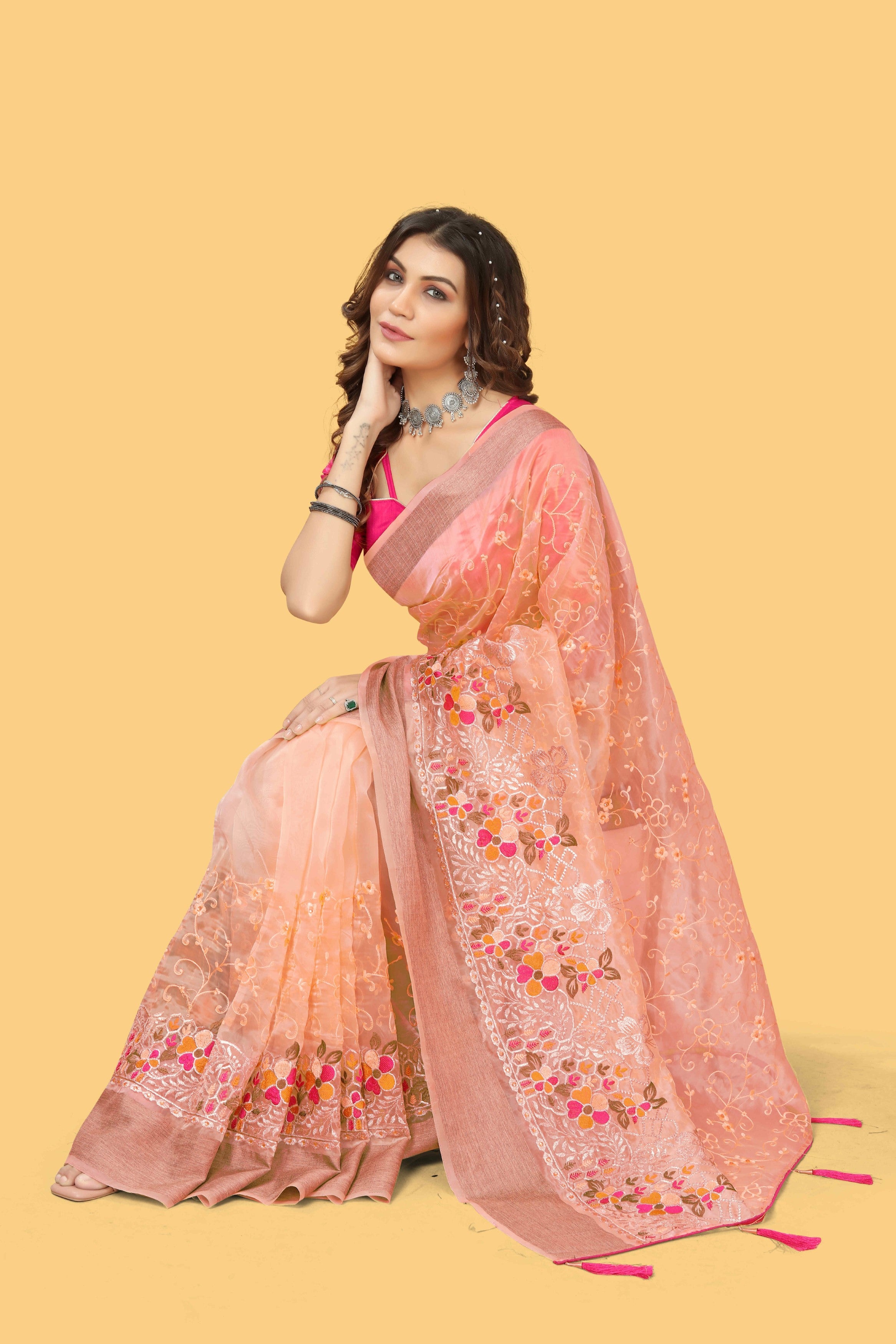 Floral embroidered organza silk saree with zari border, stone work, and contrast pink blouse