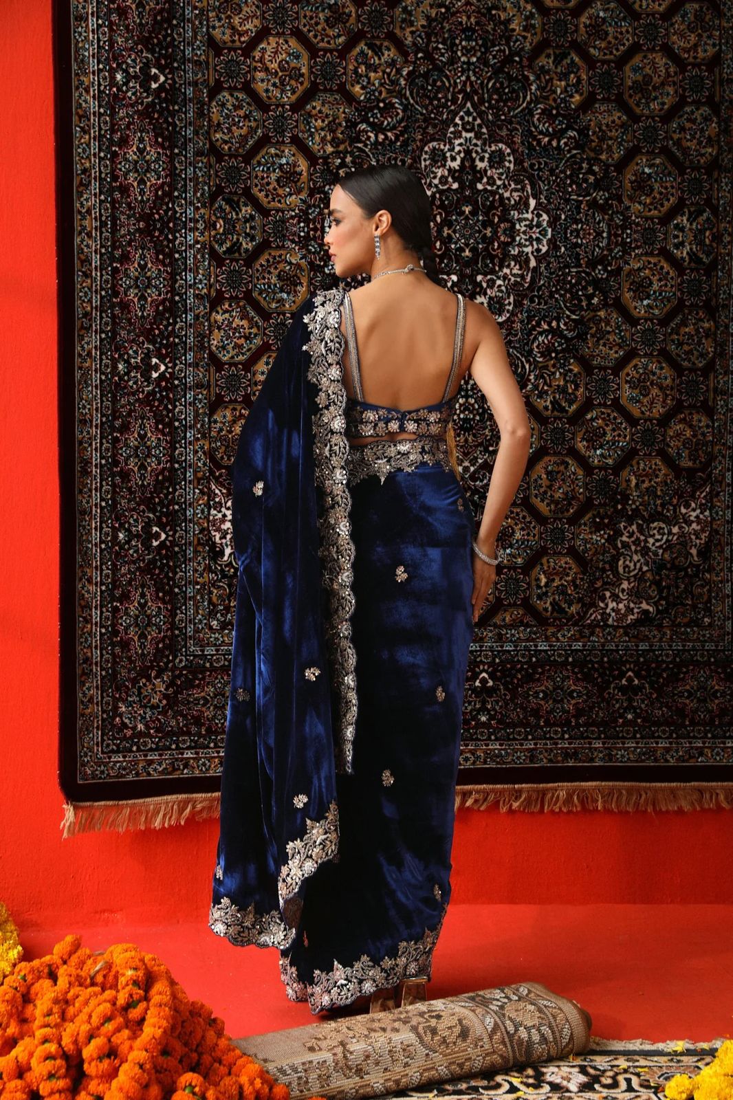 Model wearing luxurious 9000 velvet saree with silver sequence and zari embroidery cutwork border for wedding reception