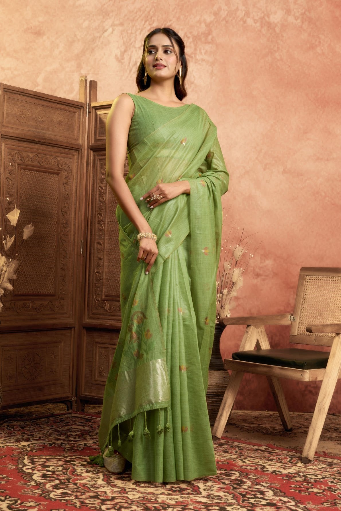 A Pure Cotton Spun Saree featuring delicate, traditional floral Jamdani weaving throughout the body. The pallu is accentuated with an elegant Zari weave border, and it comes with a running blouse piece that includes a matching floral weave border, sold as a six-piece set.