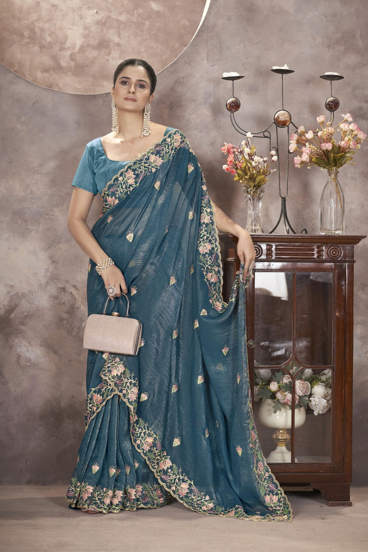 Model wearing sophisticated gold crunchy saree with floral thread embroidery and cutwork border