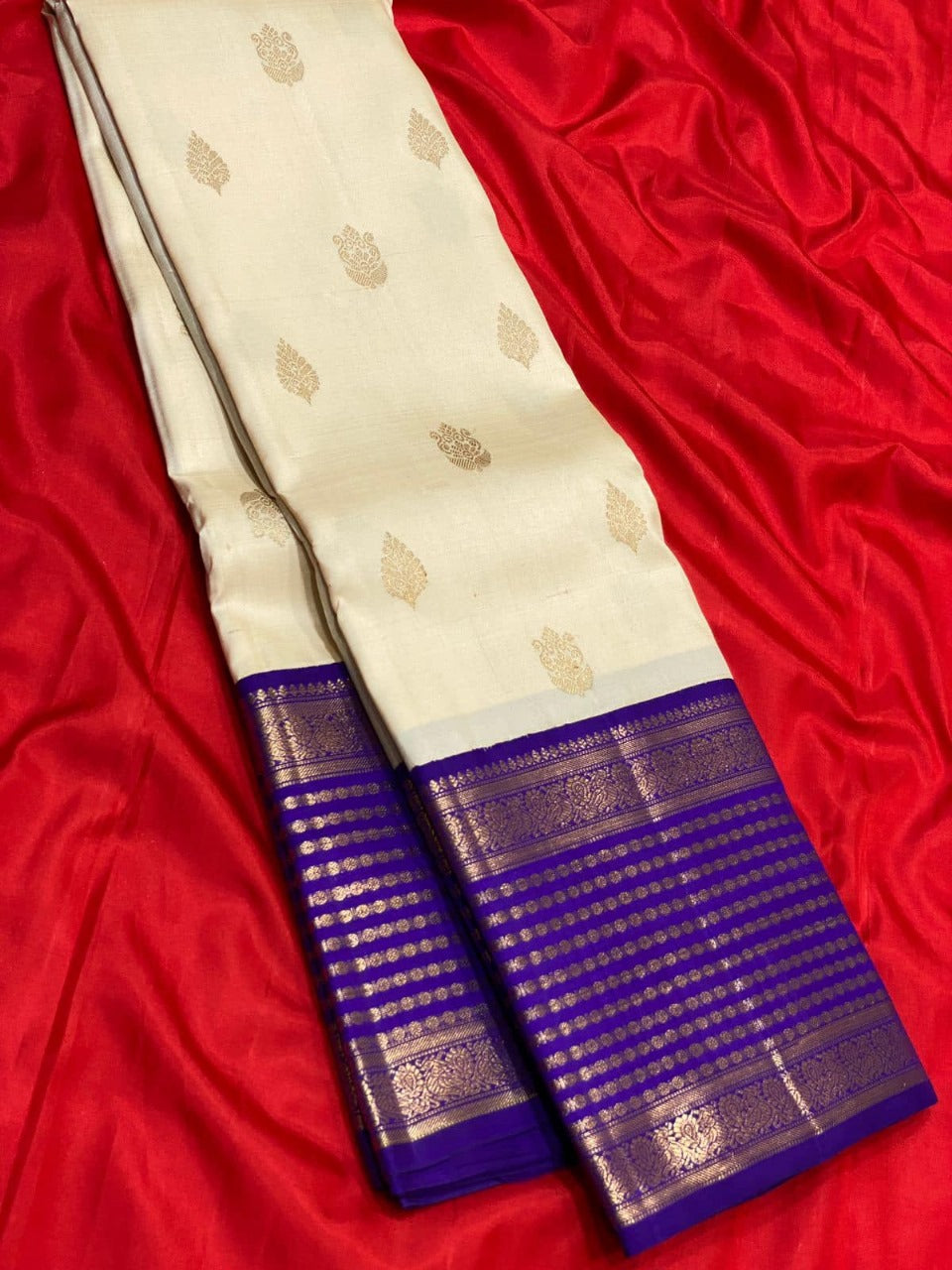 Banarasi Silk Saree in Cream Shade with Purple Pallu and Intricate Gold Zari Motifs