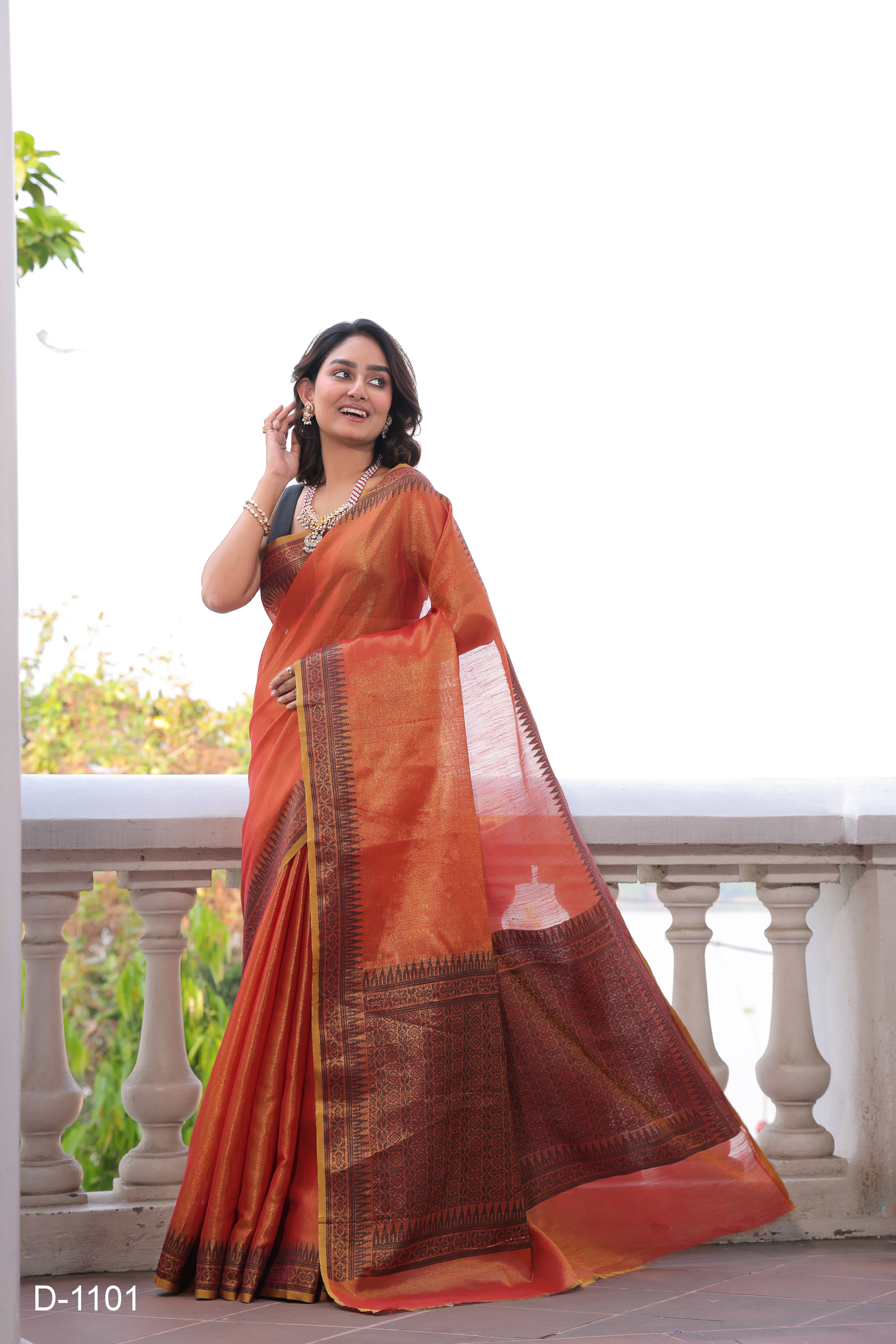 A lightweight Linen Tissue Silk Saree featuring a beautiful, delicate woven border and a rich Handloom-style pallu. The ensemble includes a matching blouse piece adorned with all-over weave butti patterns, sold as an eight-piece set.