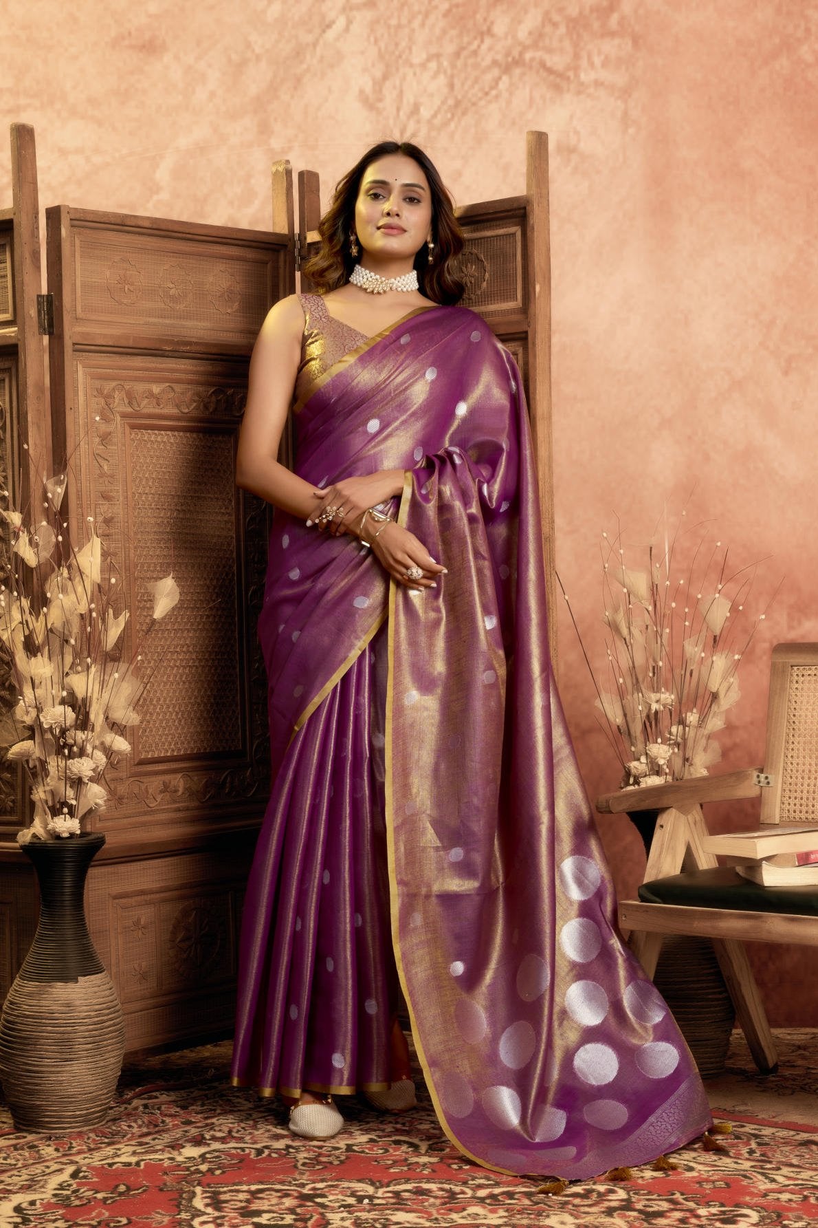 A Pure Tissue Silk Saree defined by its shimmering texture and continuous Pola Weave pattern throughout the body. The design is completed with a richly woven border detail on the pallu and includes a matching All-over Weave Tissue Silk Blouse piece, packaged as a six-piece set.