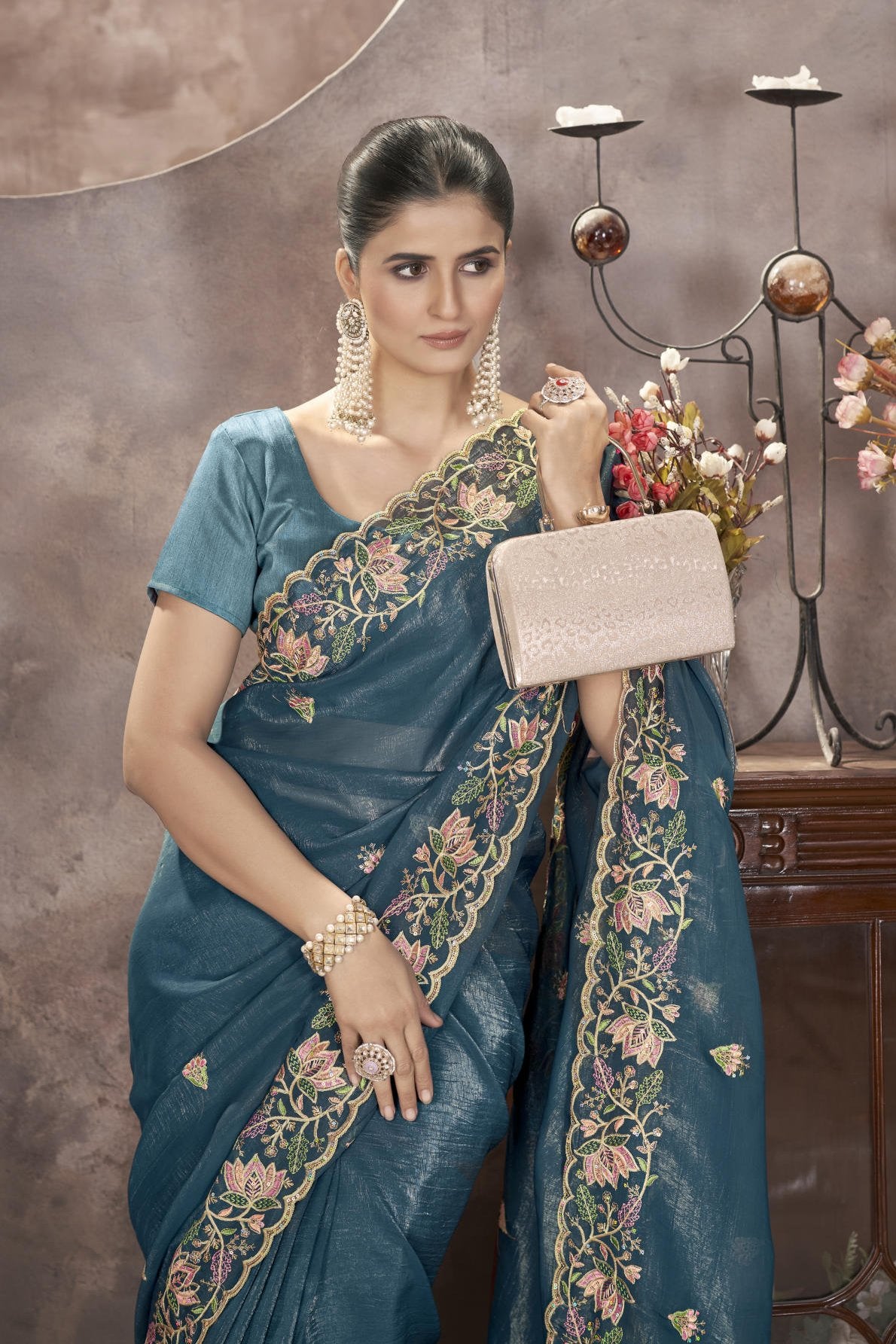 Model wearing sophisticated gold crunchy saree with floral thread embroidery and cutwork border