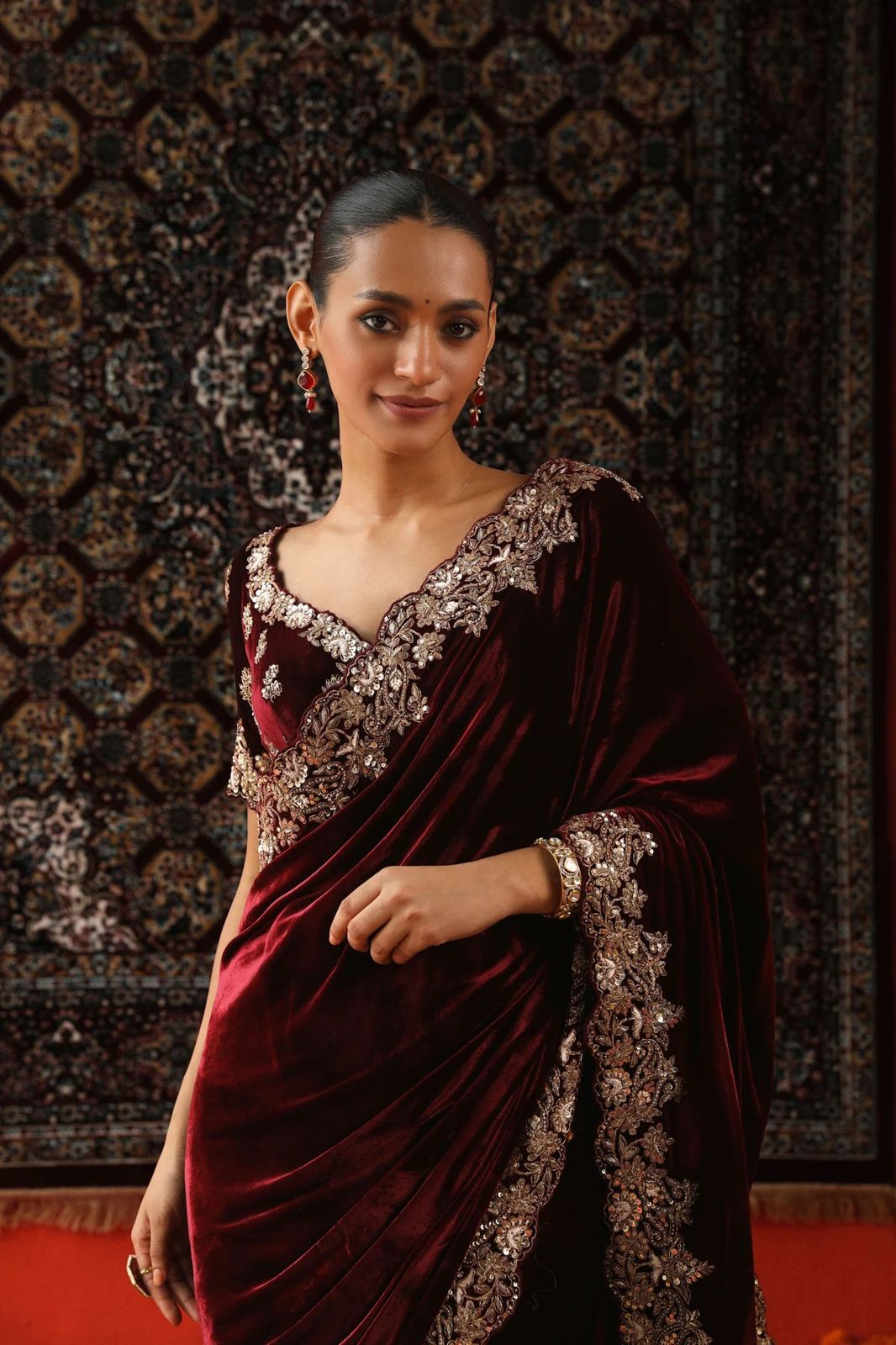 Model wearing luxurious 9000 velvet saree with silver sequence and zari embroidery cutwork border for wedding reception