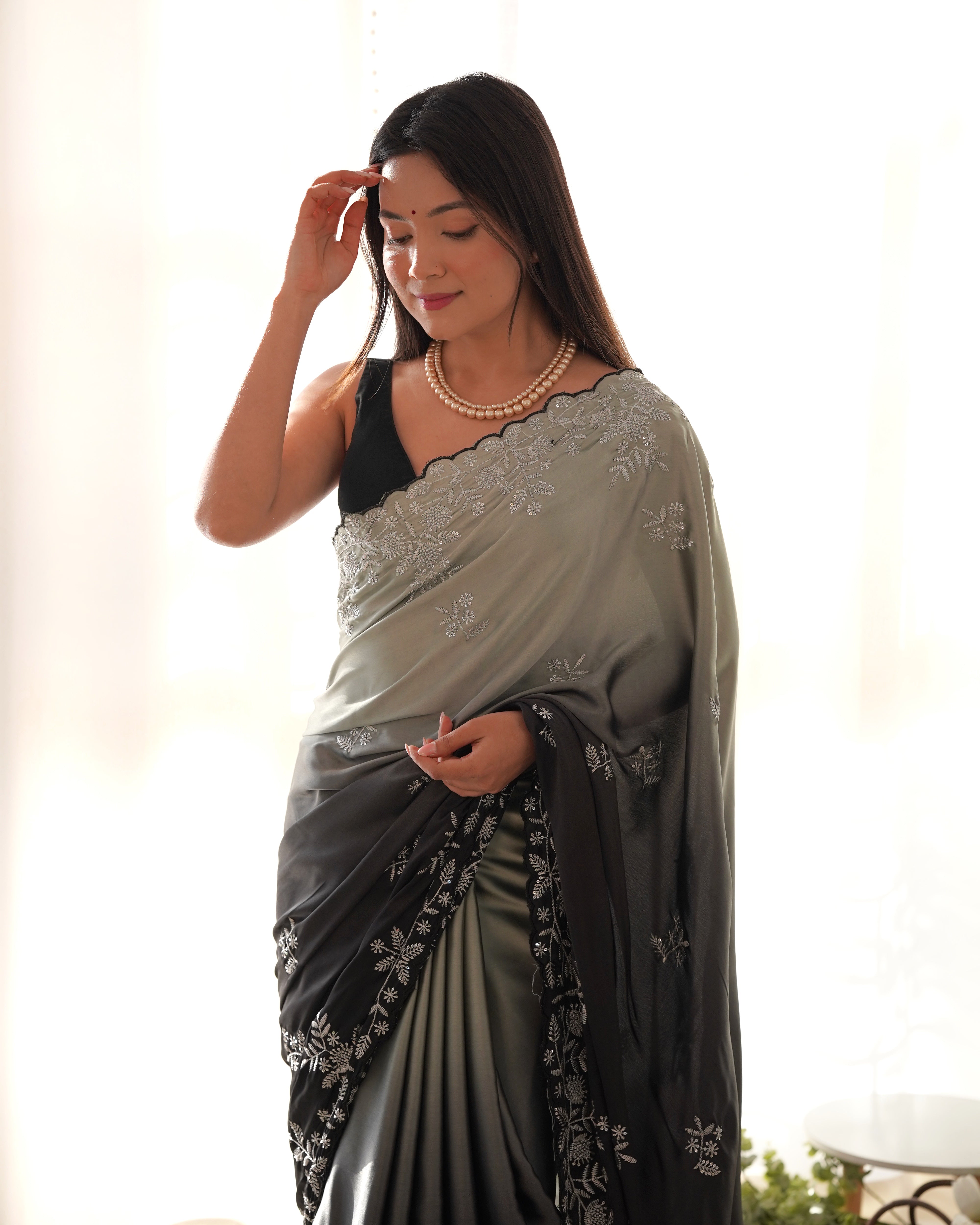 Grey and black ombre heavy Japan satin saree with intricate zari dori and sequence embroidery worn by a model