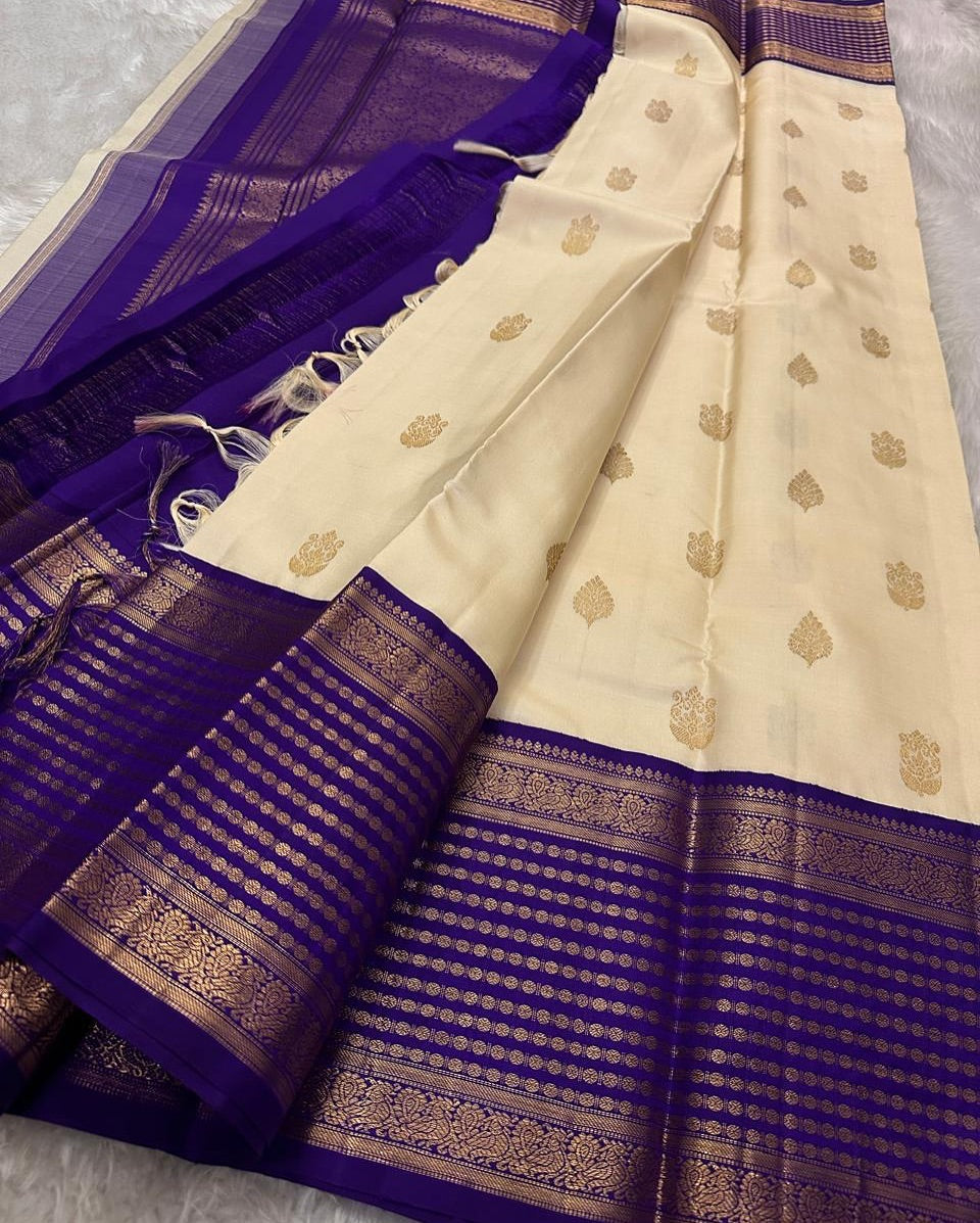 Banarasi Silk Saree in Cream Shade with Purple Pallu and Intricate Gold Zari Motifs