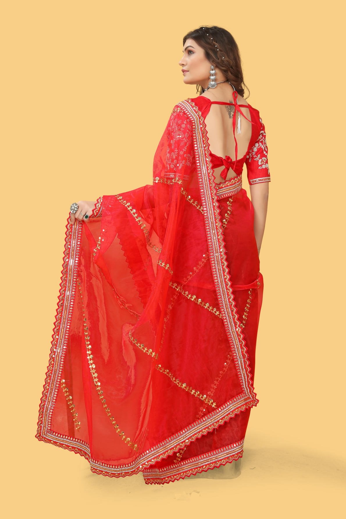 Red organza silk saree with heavy zari and sequence embroidery work worn by model for wedding party