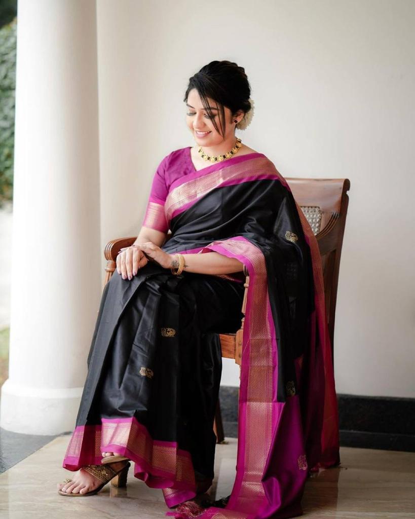 Banarasi Silk saree featuring a shimmering texture and wide gold zari contrast border; available in 4 vibrant colors including bright BLACK.