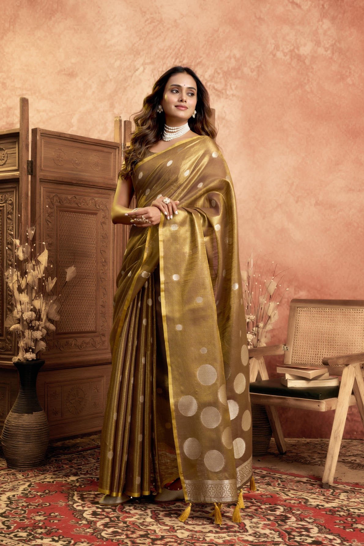 A Pure Tissue Silk Saree defined by its shimmering texture and continuous Pola Weave pattern throughout the body. The design is completed with a richly woven border detail on the pallu and includes a matching All-over Weave Tissue Silk Blouse piece, packaged as a six-piece set.