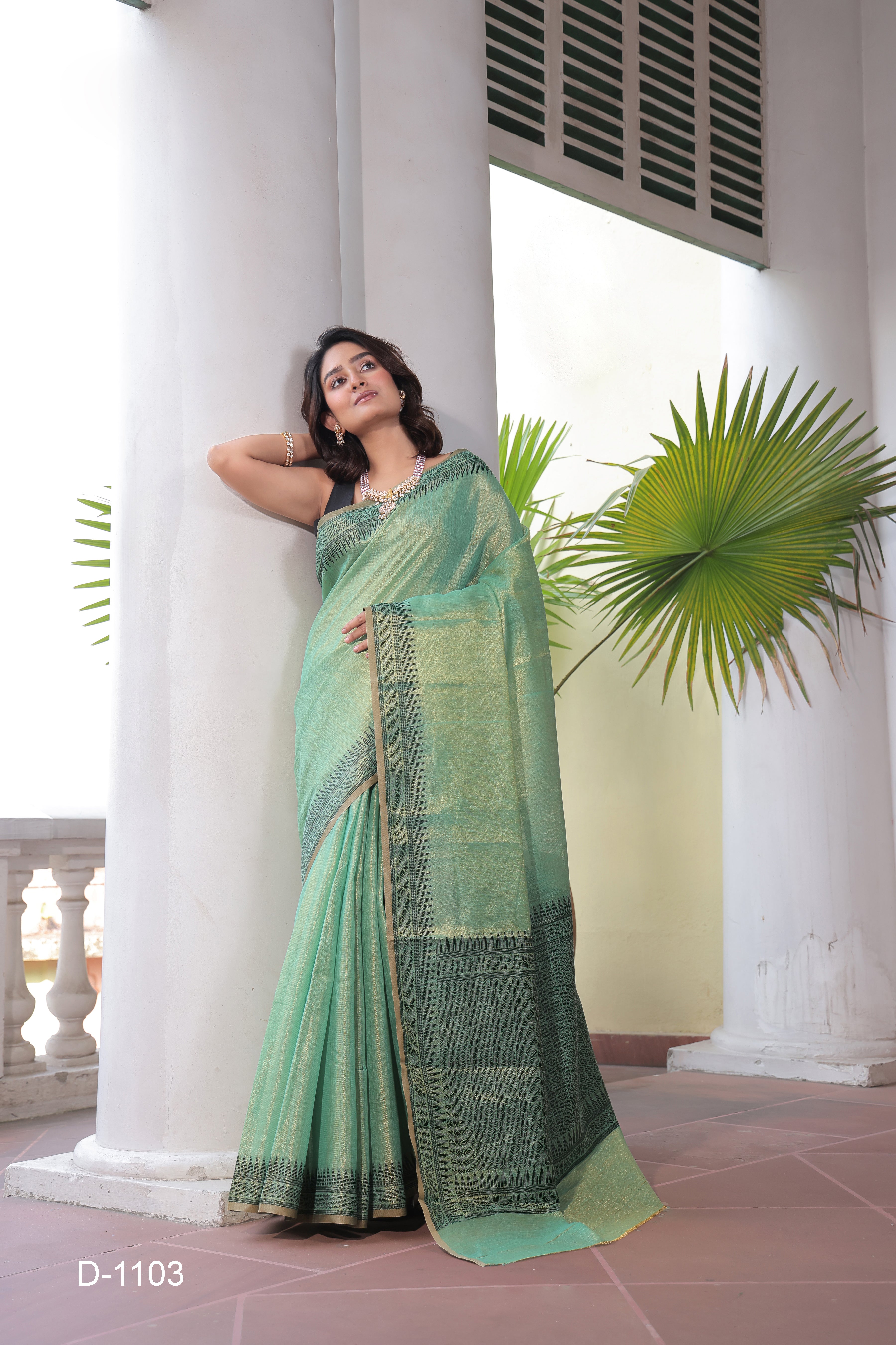 A lightweight Linen Tissue Silk Saree featuring a beautiful, delicate woven border and a rich Handloom-style pallu. The ensemble includes a matching blouse piece adorned with all-over weave butti patterns, sold as an eight-piece set.