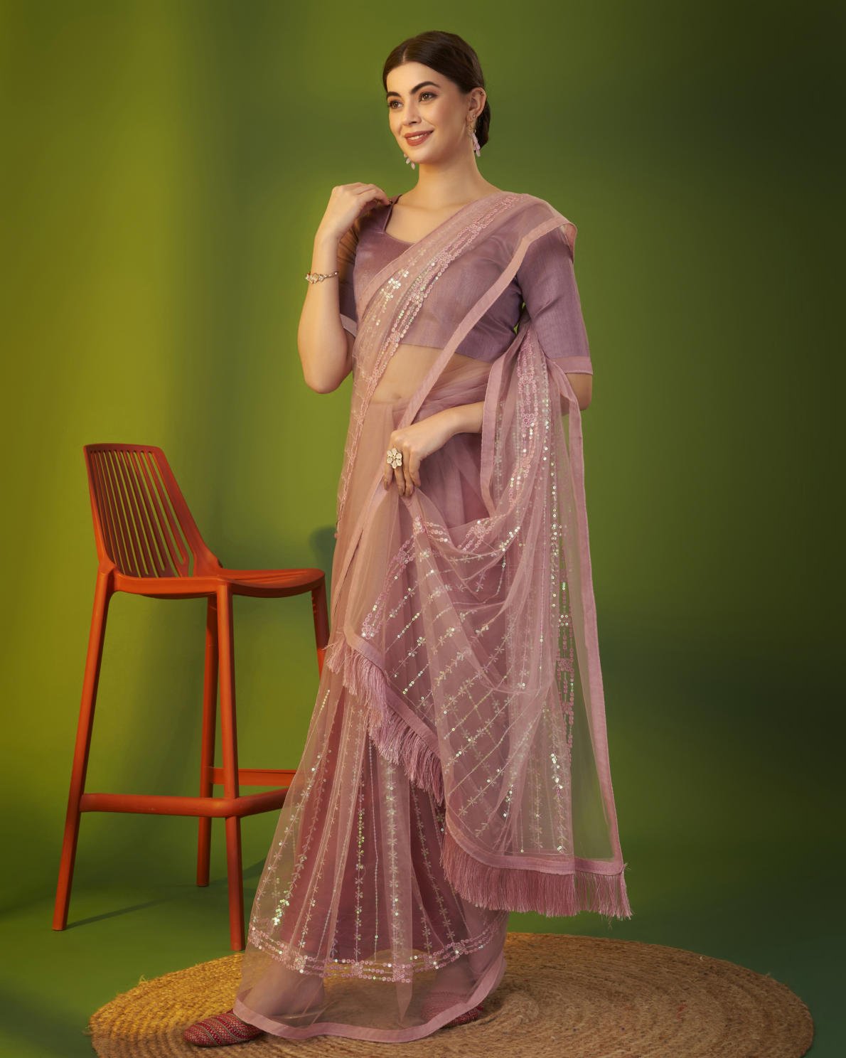 Mauve heavy butterfly net saree with 5mm sequence embroidery and tassel border worn by model