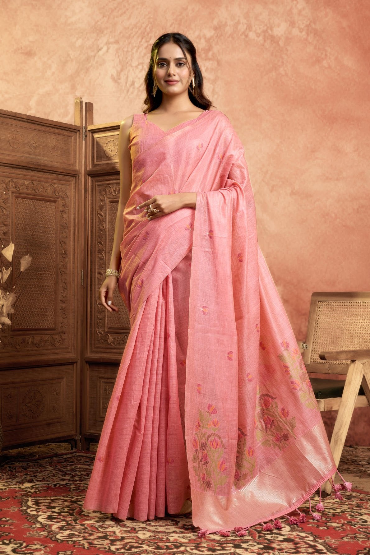 A Pure Cotton Spun Saree featuring delicate, traditional floral Jamdani weaving throughout the body. The pallu is accentuated with an elegant Zari weave border, and it comes with a running blouse piece that includes a matching floral weave border, sold as a six-piece set.