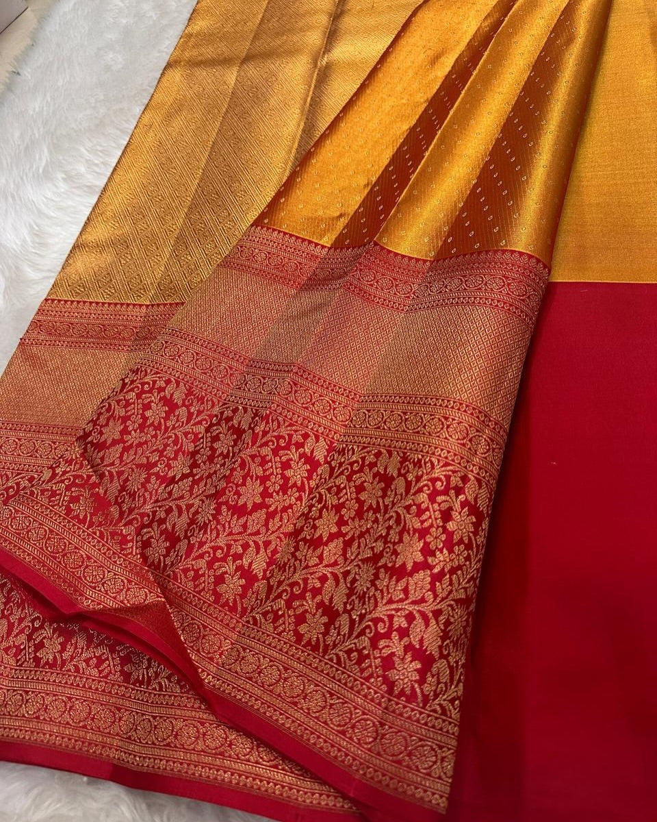 Radiant gold Banarasi Silk saree with a shimmering self-weave pattern, featuring a bold classic red border and pallu intricately woven with dense gold zari floral and ornamental motifs, elegantly draped.