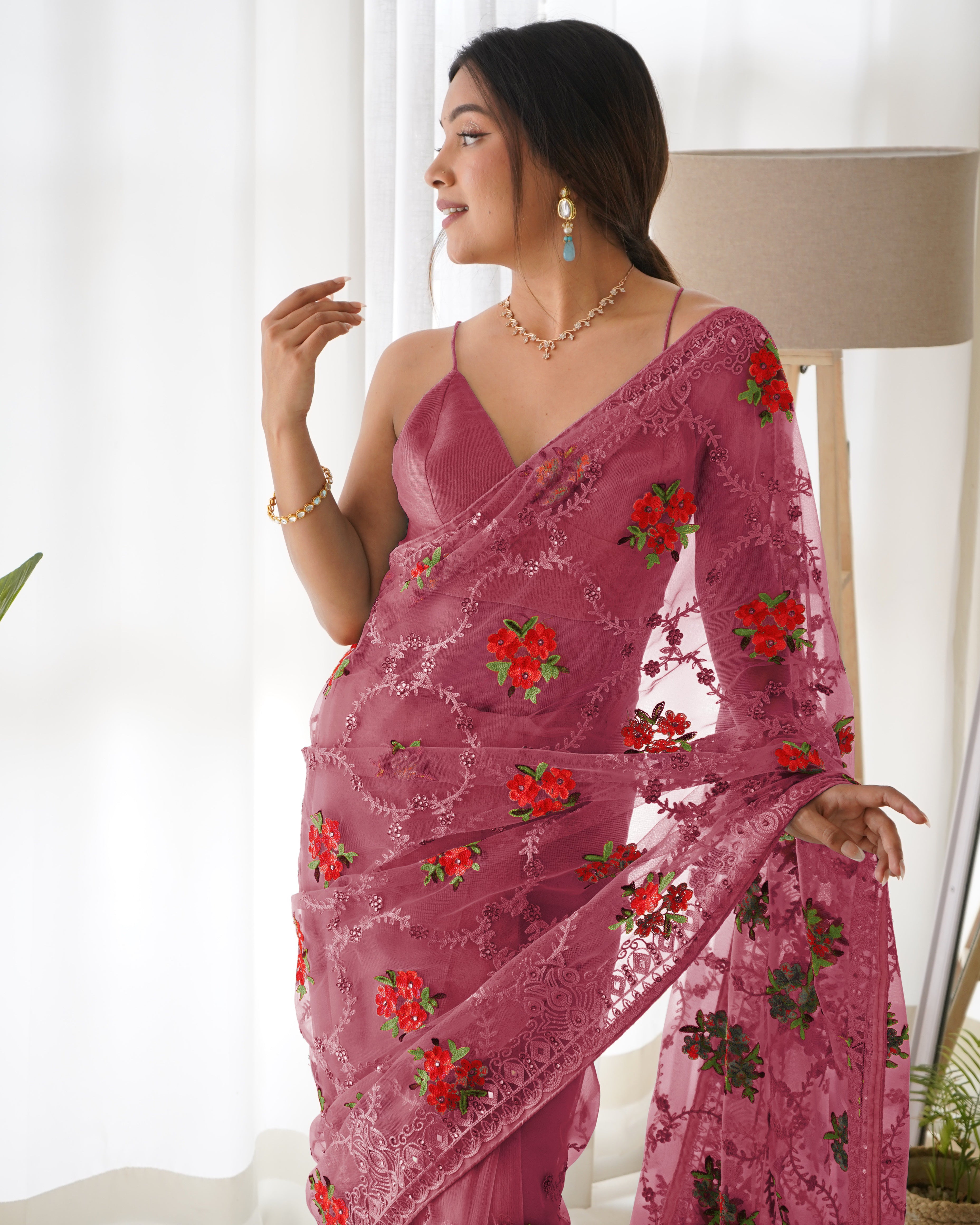 Mustard yellow heavy butterfly net saree with red and green floral aari embroidery and stone work