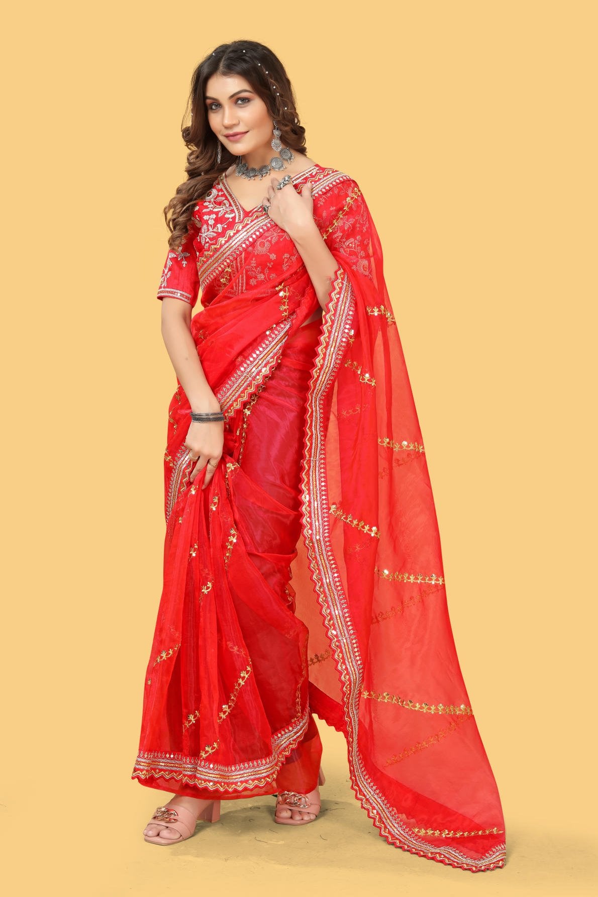 Red organza silk saree with heavy zari and sequence embroidery work worn by model for wedding party
