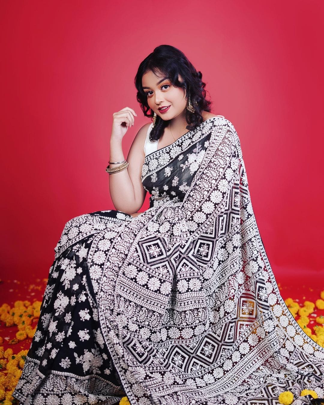 Model wearing black Fox Georgette saree with heavy white Lakhnowi thread embroidery and white silk blouse