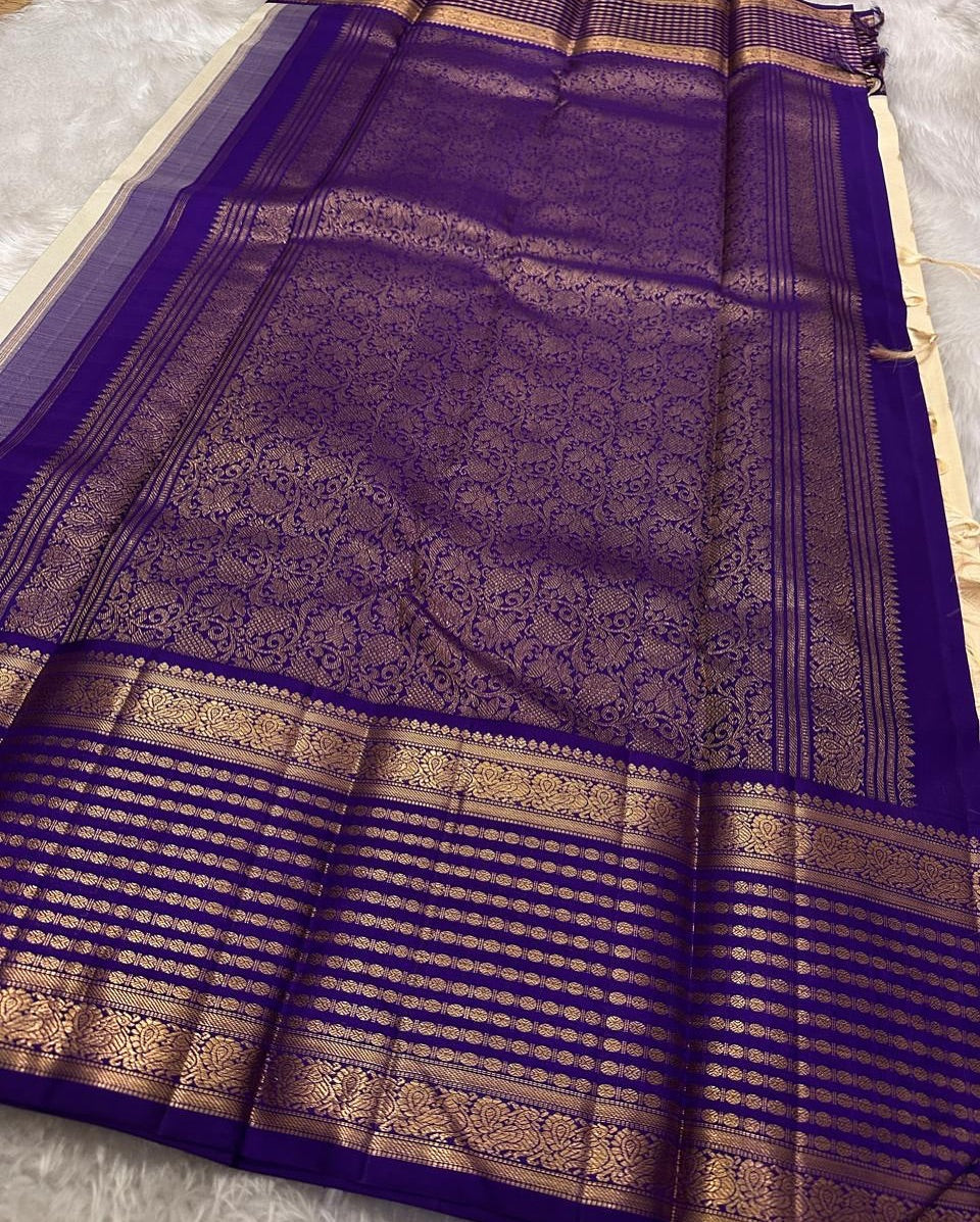 Banarasi Silk Saree in Cream Shade with Purple Pallu and Intricate Gold Zari Motifs