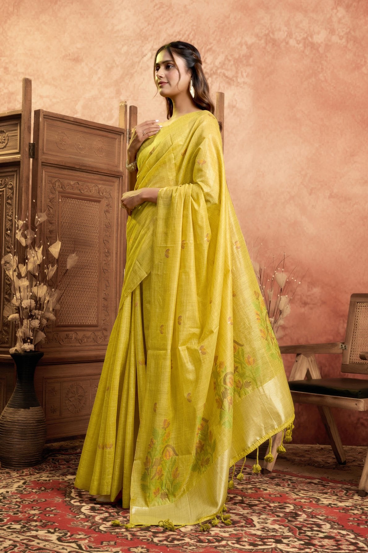 A Pure Cotton Spun Saree featuring delicate, traditional floral Jamdani weaving throughout the body. The pallu is accentuated with an elegant Zari weave border, and it comes with a running blouse piece that includes a matching floral weave border, sold as a six-piece set.