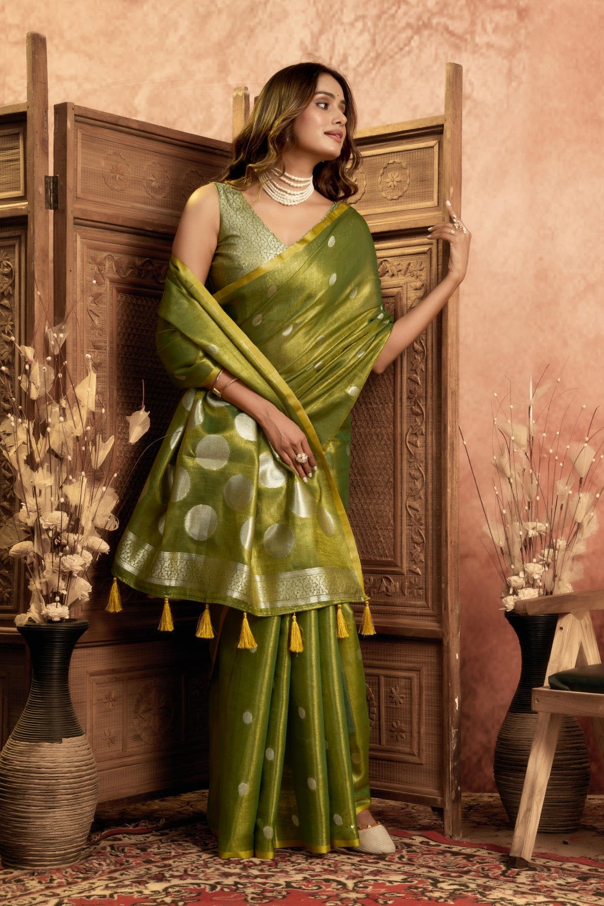 A Pure Tissue Silk Saree defined by its shimmering texture and continuous Pola Weave pattern throughout the body. The design is completed with a richly woven border detail on the pallu and includes a matching All-over Weave Tissue Silk Blouse piece, packaged as a six-piece set.