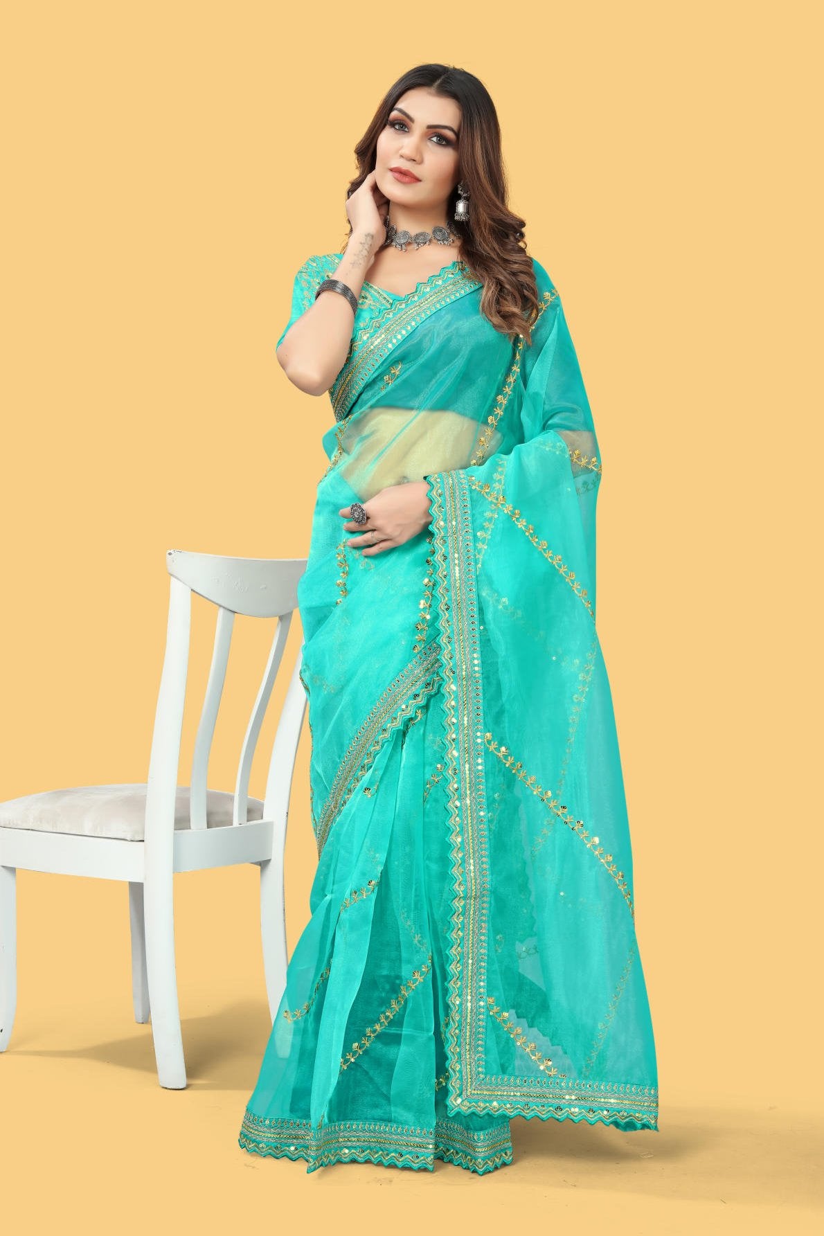 Red organza silk saree with heavy zari and sequence embroidery work worn by model for wedding party