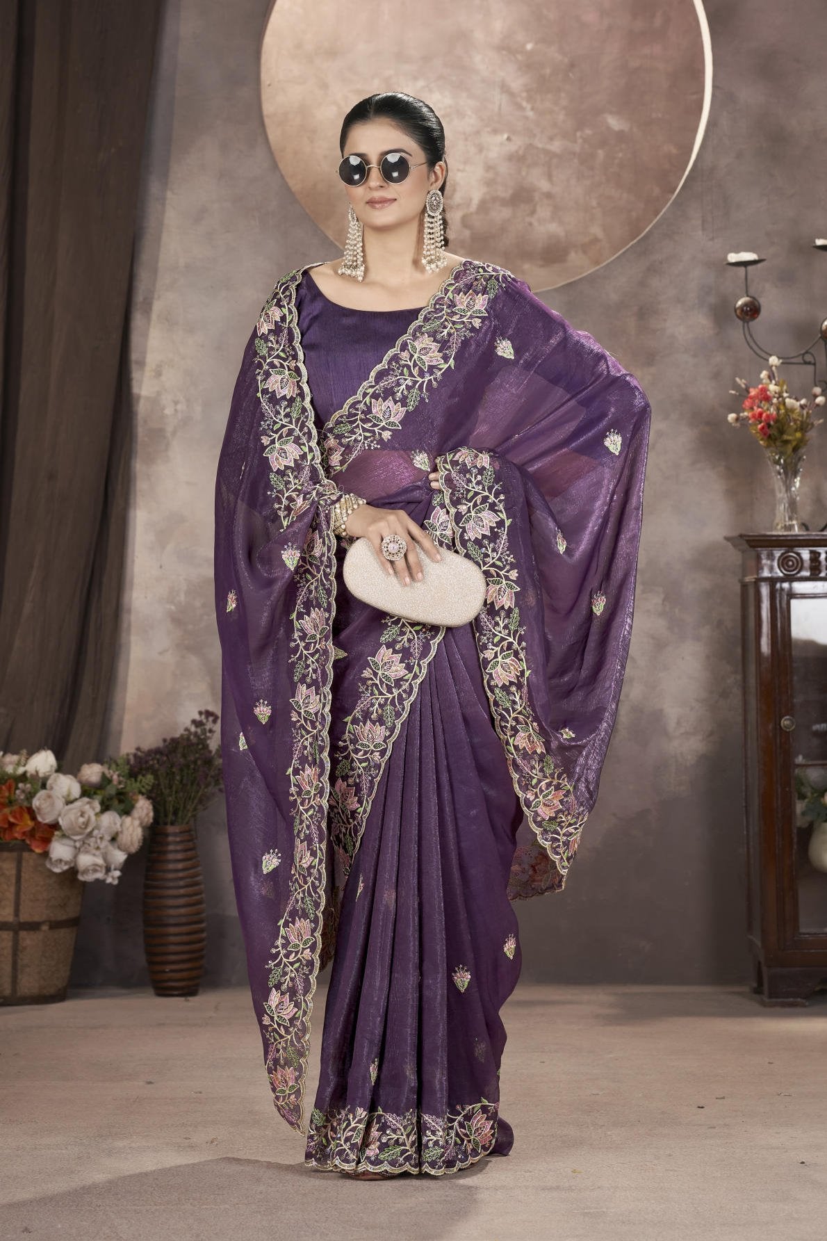 Model wearing sophisticated gold crunchy saree with floral thread embroidery and cutwork border