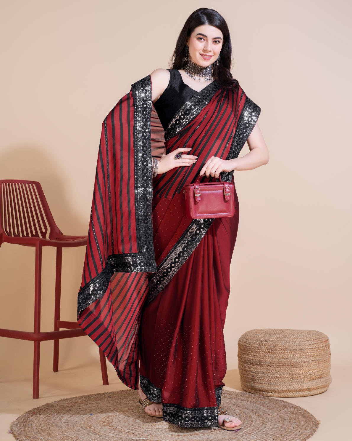 Model wearing Rangoli Silk Leheriya saree with black stripes, hotfix work, and sequin embroidered border