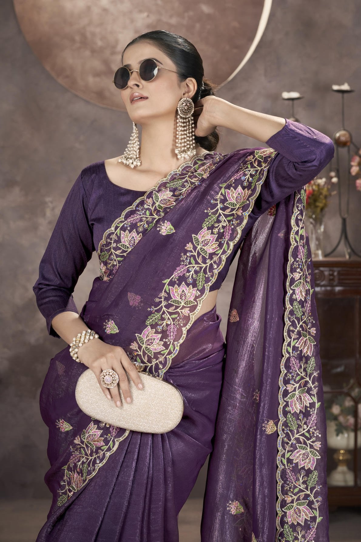 Model wearing sophisticated gold crunchy saree with floral thread embroidery and cutwork border